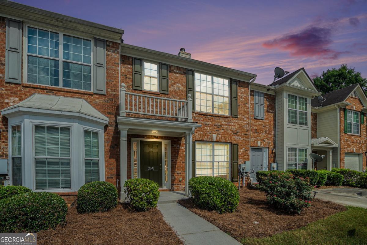 Welcome to 2846 Parkway Close, a freshly updated 2-bedroom, 2.5-bath townhome in the well-located Stonecrest Heights community. With brand new interior paint throughout and a brand new water heater, this home is move-in ready and perfect for first-time buyers, downsizers, or investors. Step into a spacious, light-filled main level featuring a large living room with a cozy fireplace and an open-concept layout that flows seamlessly into the dining area and kitchen. The kitchen includes a center island, black appliances, and plenty of cabinet space, along with a charming breakfast nook surrounded by windows for beautiful natural light. Just off the kitchen, you'll find a laundry room and a separate pantry for added convenience. Upstairs, two oversized bedrooms each feature vaulted ceilings, generous closet space, and private en-suite bathrooms-making this layout ideal for roommates or guests. The half bath downstairs is perfect for entertaining. Enjoy peaceful mornings or evenings on the back patio, which opens to a grassy yard with a wooded view-offering both privacy and relaxation. Located just minutes from I-20, Stonecrest Mall, and local shopping and dining, this home combines comfort, convenience, and style in a growing area.
