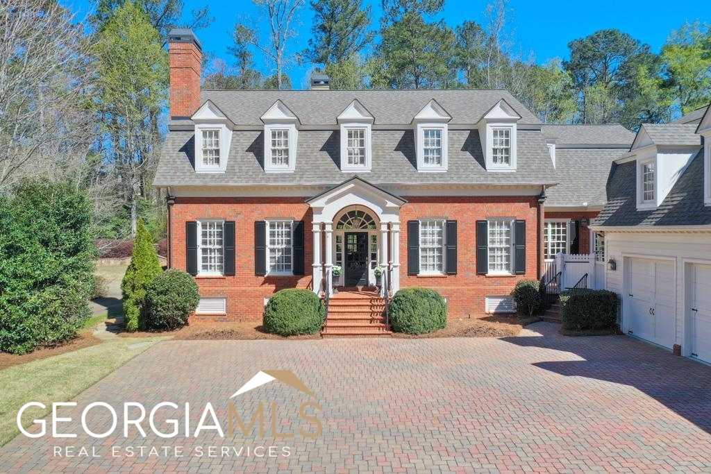 The person that said “you can’t have it all” hasn’t seen this home. Welcome home to this STUNNING Charleston style brick traditional with 3 car garage, conveniently located walking distance to Papermill Village and in East Cobb’s coveted Walton HS. The quaint charm of the Wyngrove neighborhood is undeniable when you enter the enclave of beautifully landscaped custom homes with paver driveways and tree lined streets. Situated on the best lot in the neighborhood, offering a level front and level backyard with tons of privacy, it's just the beginning of what this stunning home has to offer. The spacious floor plan is the first thing you’ll notice when you step into the 2 story foyer revealing a main level office/study with french doors for privacy and the first of five fireplaces. A generously sized dining room accommodates large holiday gatherings with double doors to a charming courtyard and a butler’s pantry. The living room features include coffered ceilings, a fireplace flanked by built-ins and a stunning view of the beautifully landscaped backyard oasis with enticing saltwater pool with waterfall and hot tub. Enjoy a closer view from the covered porch...a perfect spot to enjoy your morning cup of coffee or an outdoor meal. If the kitchen is the heart of the home, the whole family will love gathering in the open floor plan that surrounds the kitchen. A keeping room with a beautiful fireplace and beam accented carousel ceiling, offers a cozy place to relax while meals are being prepared. An eating area provides a space for everyday meals and family time. Preparing meals is a breeze in this well equipped kitchen with tons of counter space, walk-in pantry and high end s/s appliances including double ovens, subzero refrigerator, 5 burner gas cooktop, built-in microwave and a separate grilling deck. The main level owner’s suite offers a quiet retreat with privacy from the rest of the home. Relax and unwind after a busy day in the jacuzzi tub or in the steam shower of this well appointed owner’s suite. Upstairs are 3 spacious bedroom SUITES, each with their own private bath, walk-in closet and linen closet. An upstairs loft provides a gathering place for video games or a study area. The terrace level offers a variety of activities and a perfect place to entertain family and friends. Features include….a soundproof home theater room with top of the line A/V equipment and automated curtains for an authentic movie going experience, two recreation rooms, a sitting area with fireplace, a 1300+ bottle temp controlled wine cellar with tasting room, a workout room with sauna, and a built in bar with refrigerator, 2 drawer dishwasher and ice machine. The terrace level also includes two guest rooms with 2 full baths. From the backyard oasis, lovely outdoor spaces and multitude of terrace level activities....Staying home has never been this much fun!! This home will not last....schedule a private showing today!