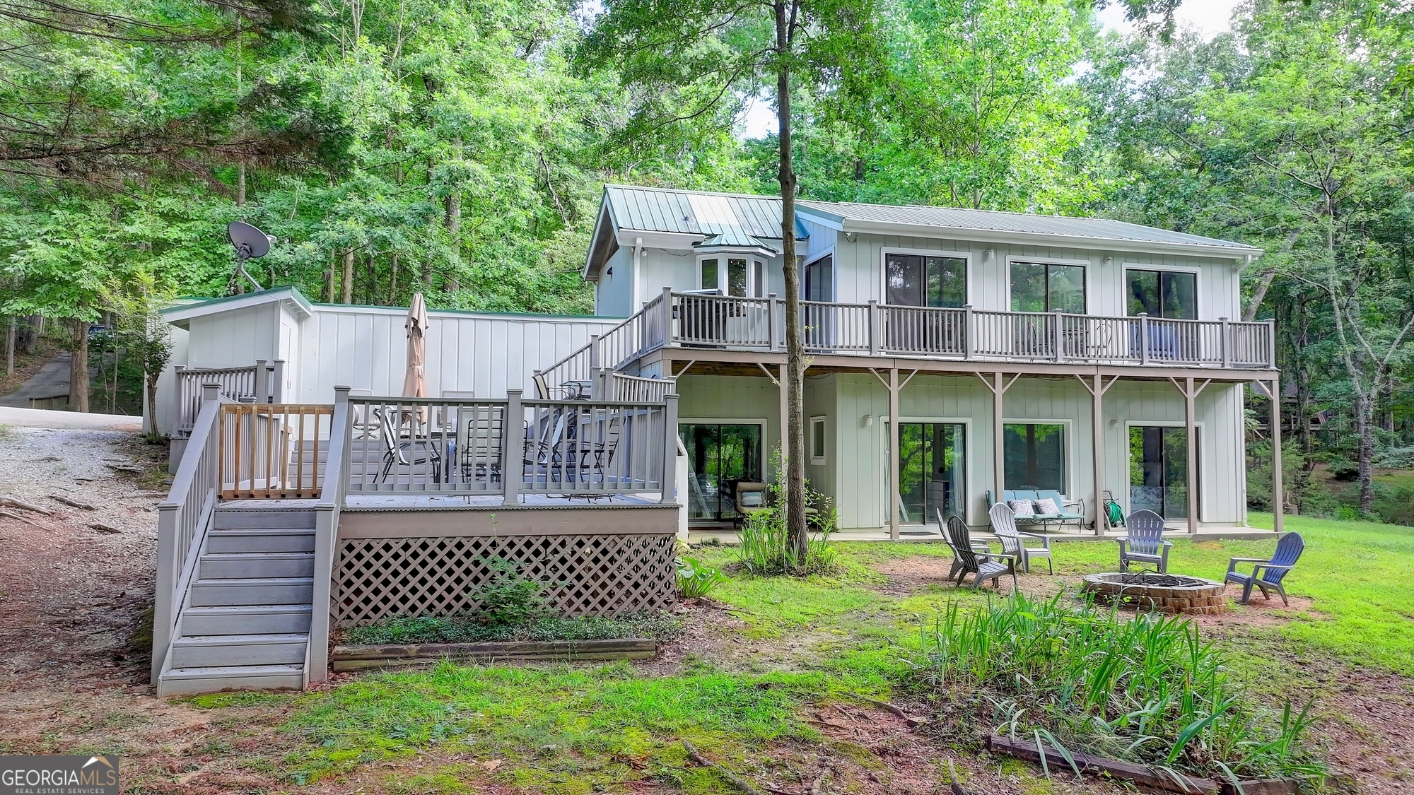 23K Price Improvement! FULLY FURNISHED LAKEFRONT RETREAT - BOAT & TRAILER INCLUDED! Dreaming of your own slice of lakeside paradise? This beautifully updated, turnkey lake house comes fully furnished including a 1997 Larson 21-ft speedboat with trailer, inboard V-8 motor (recent long block replacement), and freshly reupholstered interior. Nestled in a peaceful setting, this home offers more than just a view it's a lifestyle. Inside, enjoy a bright, modern kitchen with sleek new stainless-steel appliances and a high-end hood venting outdoors. The primary bathroom has been completely renovated with a luxury tiled shower, sliding glass doors, updated lighting, and a new vanity. All bathrooms feature brand-new toilets, combining comfort with contemporary design. Step outside to find lake-friendly upgrades: a covered carport for your boat or car, a roof over the boat slip, a brand-new dock gangway, and a cozy fire pit in the backyard perfect for evening gatherings. Tree removal has opened up stunning lake views, enhancing the natural beauty around you. Enjoy the convenience of a shared dock the last covered slip on the left is yours, and shared maintenance means costs are divided among just eight owners. Whether you're looking for a peaceful getaway or a lucrative short-term rental, this fully loaded lakefront home is move-in ready. Answer the call of the lake today.