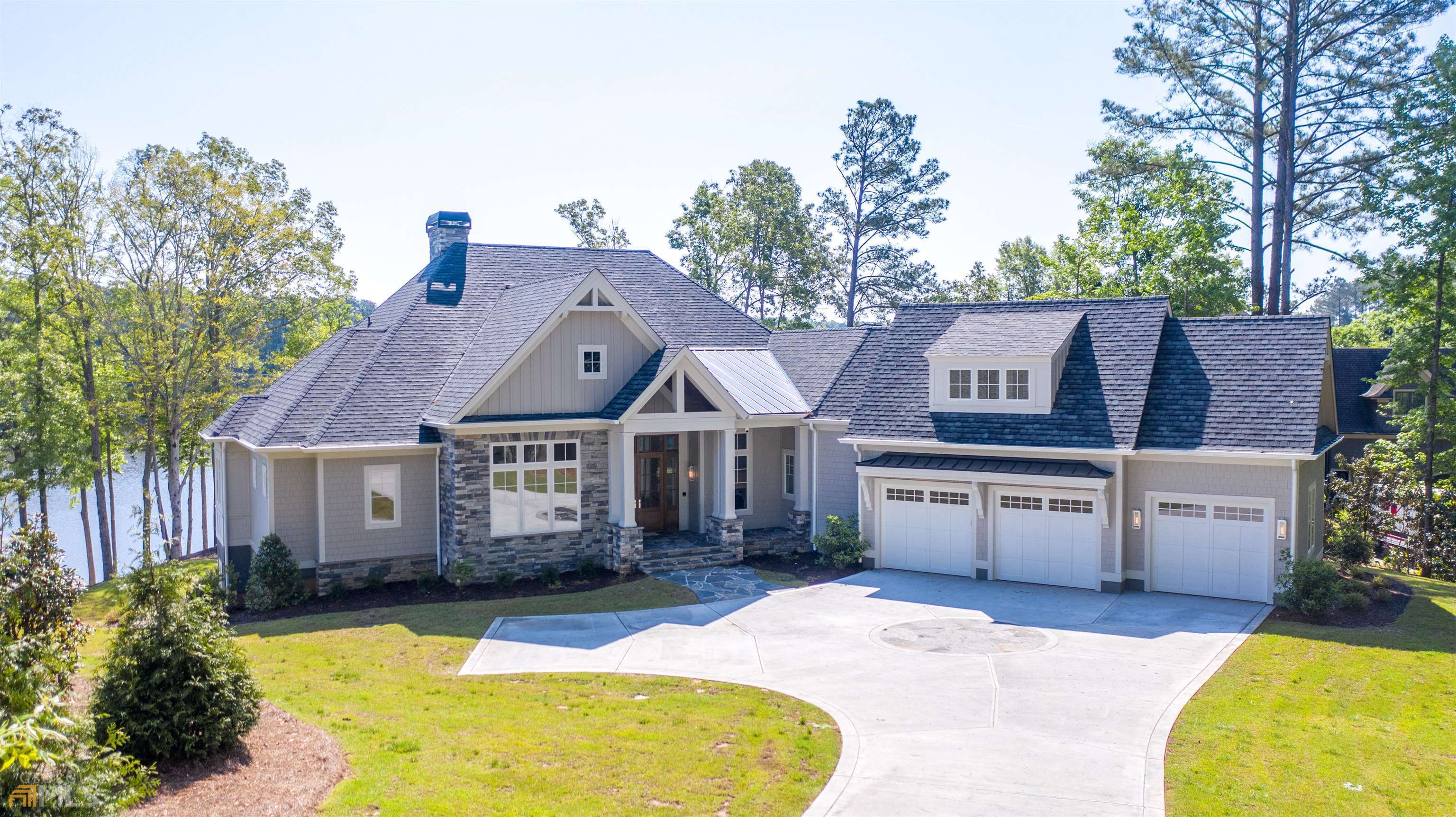 UNSURPASSED QUALITY AND HIGH-END DETAILS ARE EVIDENT THROUGHOUT THIS CUSTOM, ONE OF A KIND LAKEFRONT HOME IN REYNOLDS LAKE OCONEE, LOCATED WITHIN THE HIGHLY DESIRABLE RICHLAND CREEKSIDE OF LAKE OCONEE. This luxurious home is ideal for relaxing and entertaining, offering expansive lake views in all directions, 6,536 square feet of unparalleled craftsmanship, with wide plank naturally-aged wire brushed oak wood floors, 7 bedroom and 7.5 bathrooms with custom closets-featuring 7 en-suite oversize bedrooms, 2 owner suites on the main level, and extra-large 7th bedroom/bonus suite over the garage. Thassos & Marble tile and countertops throughout the home, along with 12+ foot ceilings that enhance the main level, highlighted by vaulted/coffered, tongue and groove detail, and beams. Two full laundry rooms - main and terrace level. Two indoor fireplaces -main and terrace level. Wolf/Sub Zero kitchen and bar, and terrace level wet bar package. No detail has been overlooked with your custom lighting package, Open-Cell spray foam insulation and full home Control4 Smart-Home Automation System; which controls lighting, video, sound, AC, pool & spa, and security & cameras. Ready for your whole home generator and elevator. Seller is making a Club Membership Available.