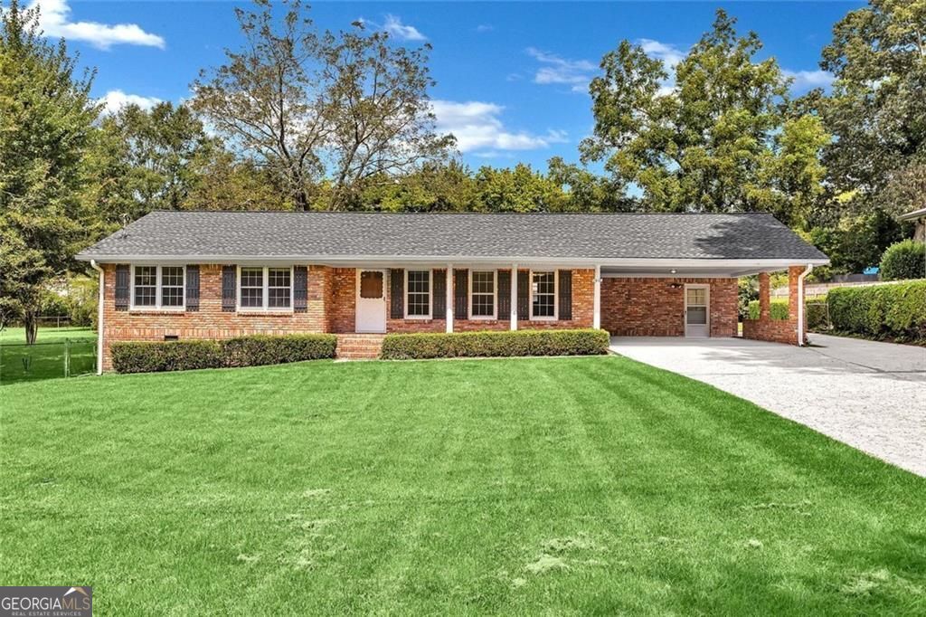 Nestled in the welcoming community of Mableton, Georgia, this home is a mid- century all brick jewel with enduring appeal. It offers a unique opportunity to invest in a home with solid foundations. It encompasses spacious living areas, including a rare to find living/dining room combination. A separate family room and its adjoining sun room are perfect informal spaces for the family to enjoy! Imagine creating cozy gathering spaces and private retreats within these walls, designing each area to reflect your personal tastes and needs. The sought after mid-century style home carries a sense of history and character. Consider the possibilities for making this house your home. This property offers a chance to create a lasting haven within a well-established neighborhood. Open and bright throughout, it features 3 spacious bedrooms with hard to find ample closet space. The 2 fully tiled baths ,one of which is featured in an ensuite, are sure to meet the needs of its new owners. Spacious kitchen features adequate counter space and room for a dinette set for quick meals.The outside completes the package with an oversized lot perfect for outdoor family fun and entertainment. Outdoor movie nights have been a big hit here! An added bonus is the backyard workshop ready for the crafter or woodworker in the family! Features 2 lots combined for added yard space. See this one and you are home! Stop looking and start living.