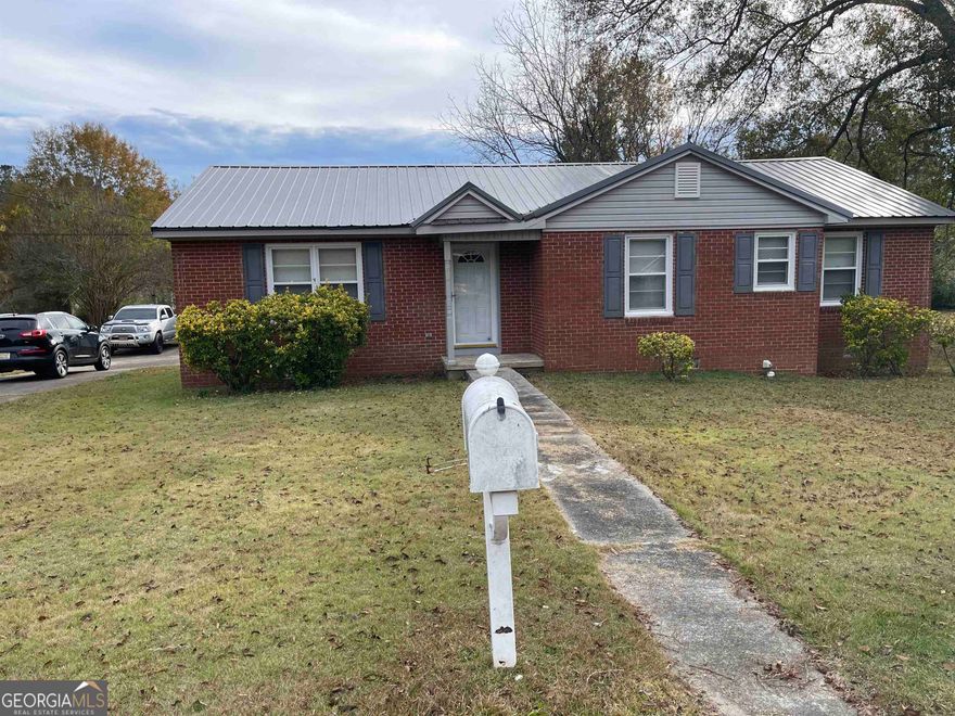 This is a move in ready home. Home has been completely repainted, hardwood floors in living room and 3 bedrooms( the hardwood floors are in excellent condition) tile in kitchen and laundry room.  There is a new refrigerator(side by side), new dishwasher and practically new stove and microwave.  There is a 1500 square ft shop in the backyard that is wired. THe yard is a beautiful level lot with several shade trees.