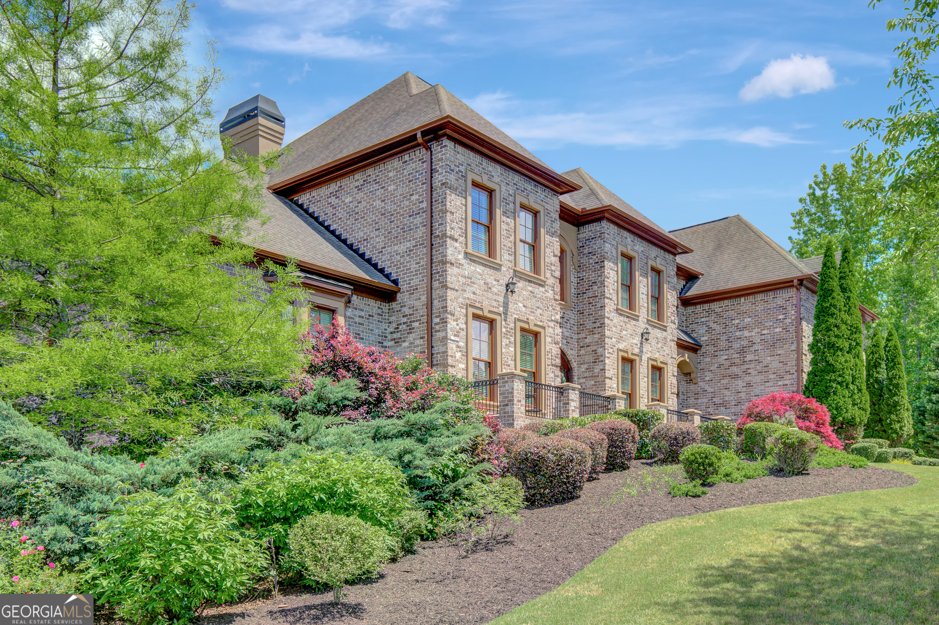 COME EXPERIENCE ESTATE LIVING IN RIVER OAKS, one of Fayette County's most prestigious communities! RECEIVE A $10K BUYER'S CREDIT AT CLOSING WITH AN OFFER ACCEPTED AND CLOSED BY 10/31/25. This four-sided brick home, situated on 2.37 acres, features a two-story foyer, a great room with expansive windows, a kitchen with keeping room, formal living and dining rooms, powder room, and a main-level owner's suite with separate bath vanities and closets. An additional guest bedroom with private bath is also located on the main floor. Upstairs includes three spacious bedrooms with en suite bathrooms, a large bonus room, and an inviting loft area. The basement offers a billiard room with wet bar, a double-sided fireplace, a comfortable living space suited for entertainment, and a fitness/flex room. Ample unfinished basement space provides opportunities for future customization and storage. The professionally landscaped yard is suitable for a swimming pool. River Oaks combines tranquil estate living with proximity to key amenities-just 2 miles from I-85, 25 minutes to downtown Atlanta, 15 minutes to Hartsfield-Jackson Airport, and close to Tyrone, Peachtree City, and the Town of Trilith. This property presents a distinguished opportunity in a prime location.