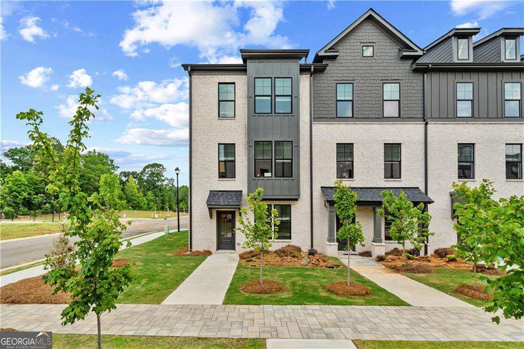 READY RIGHT NOW! The Landon Plan at Silverock by DRB Homes - This beautiful townhome offers 3 Bedrooms, 3.5 Baths, and a 2-car rear entry garage with convenient access through both the main entry and garage. The split bedroom layout offers privacy, with the spacious Owner's Suite featuring dual vanity sinks, a separate shower, and a walk-in closet. The open-concept design creates a seamless flow from the Family Room to the Gourmet Kitchen, perfect for entertaining. The kitchen boasts stainless steel appliances including a cooktop, microwave, wall oven, and dishwasher. Quartz countertops, a stylish tile backsplash, and LVP flooring throughout complete the contemporary look. Blinds and window screens are included for added convenience. On the lower level, a large flex area provides the option to transform it into a 4th bedroom or study, adding versatility to the space. The middle floor features a bright, open kitchen, family room, and breakfast area, all flooded with natural light. A deck off the family room offers a perfect spot for outdoor relaxation. Upstairs, the luxurious Primary Suite offers a walk-in closet and a spa-like en suite bathroom with dual sinks and a tile shower. Enjoy the cool, relaxed vibe and close proximity to McDonough's newest shopping area and restaurants located off Jonesboro Rd and easy access to I-75, offering a quick commute to Downtown Atlanta and Hartsfield-Jackson Atlanta International Airport. Not only is Silverock an ideal location, but it also resides in one of Henry County's highly sought-after School Districts. The community amenities include a dog park, playground, and community pavilion, adding to its charm. Don't miss the opportunity to elevate your lifestyle in these exquisite townhomes at Silverock. Experience the epitome of luxury living in McDonough, GA, where every detail is crafted with your utmost satisfaction in mind. Note: Pictures are not of the actual home. Please note: If the buyer is represented by a broker/agent, DRB REQUIRES the buyer's broker/agent to be present during the initial meeting with DRB's sales personnel to ensure proper representation.