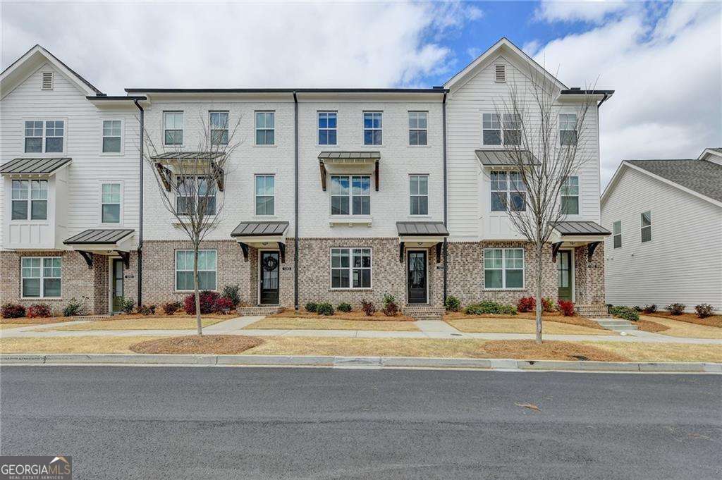 LOCATION! LOCATION! LOCATION! This luxurious, modern, LIKE NEW, AND MOVE-IN READY North Gwinnett School District townhome is within walking distance of Suwanee Town Center, trails, parks, restaurants, walk to Suwanee Parks, and much more! The gourmet kitchen features quartz countertops, a tile backsplash, and a generously sized island, perfect for culinary creations and casual gatherings. Entertain effortlessly as the kitchen seamlessly flows into the dining and family rooms. Main bedroom w/walk-in closet. The master bath has a large/luxurious oversized shower. Laundry upstairs near the master bedroom. Each bedroom offers the luxury of a private bath, ensuring comfort and privacy for all. With beautiful hardwood floors on the main level and oak stair treads adding a touch of elegance, every detail of this home exudes sophistication.