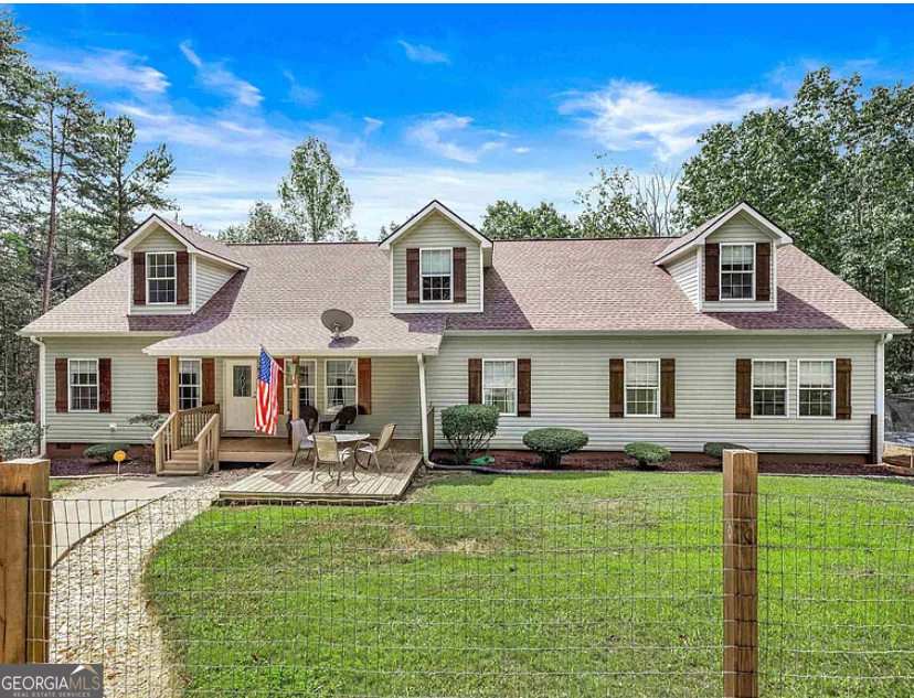 Welcome to 456 Wynn Shoals Road in Alto, Georgia - offered at $520,000. This spacious two-level traditional home is nestled on 5 private acres and offers the perfect combination of space, comfort, and privacy. With 6 bedrooms and 3 full bathrooms, this residence provides plenty of room for living, entertaining, and future growth in a beautiful country setting. The layout is thoughtfully designed with 4 bedrooms and 2 bathrooms on the main level, providing convenience and functionality, while the upper level adds 2 additional bedrooms and 1 bathroom, creating flexible options for guests, offices, or private retreats. This arrangement makes the home ideal for those needing both shared and individual spaces under one roof. The heart of the home is the open kitchen, complete with a kitchen island that adds workspace, storage, and a natural gathering spot. The kitchen flows seamlessly into the dining and living areas, making it a welcoming hub for everyday living and special occasions. Anchoring the living room is a cozy fireplace, offering warmth and charm while creating a focal point for gatherings. Hardwood flooring, natural light, and spacious rooms further enhance the inviting feel throughout. This property also includes valuable outdoor features. With 5 acres of partially wooded land, you'll enjoy a balance of open areas, shade, privacy, and gently sloped terrain. The land offers flexibility for gardening, outdoor projects, or simply enjoying the quiet of a rural setting. A fenced section enhances functionality, while a shed provides extra space for storage, tools, or hobbies.