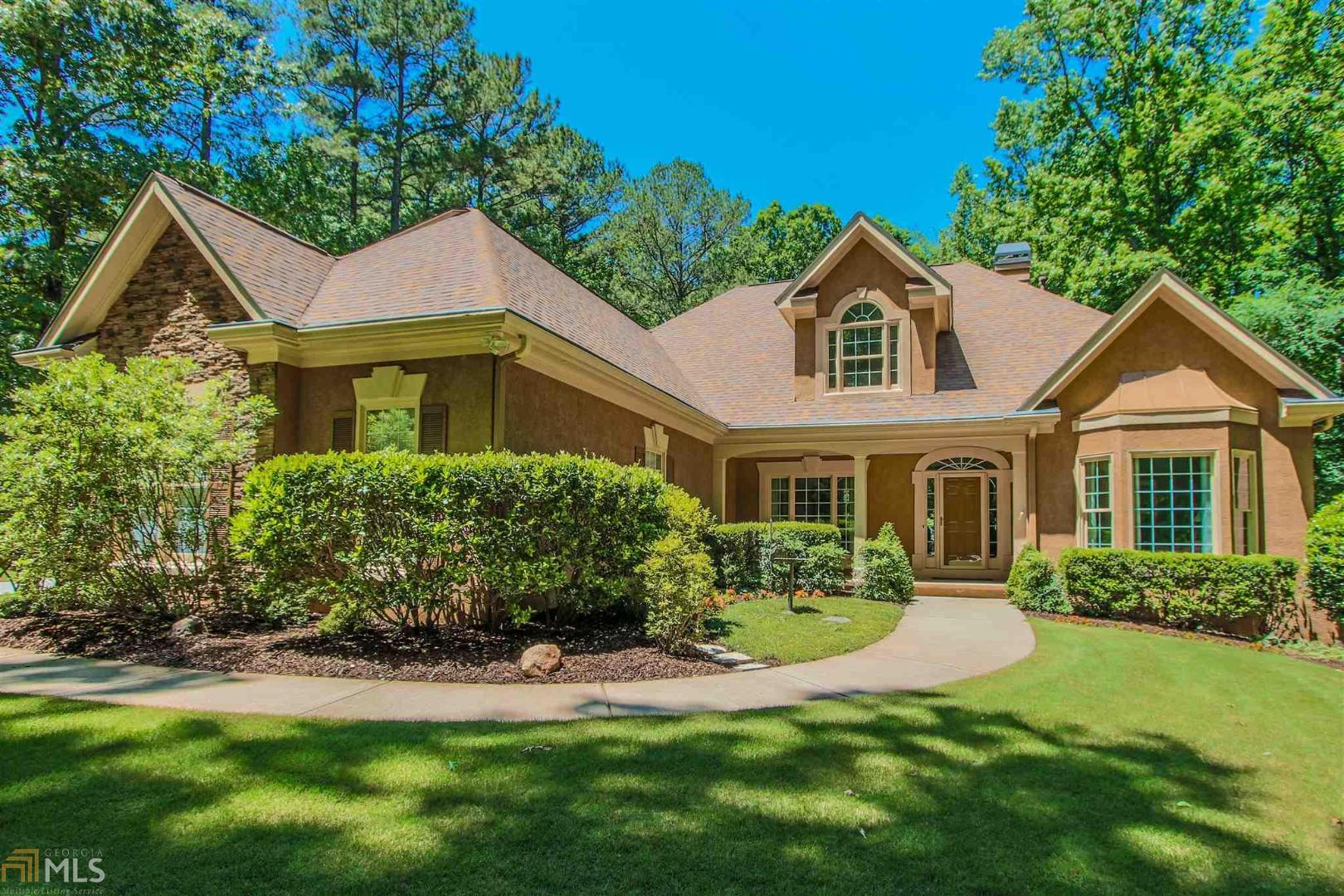 QUIET PEACEFUL SUMMER NIGHTS at the Lake listening to Frogs by your fire pit, tree house or Trex back deck on this 2.85 acre slice of Serenity * This Spacious Home sits at the edge of P’tree City fully accessible by golf cart * Freshly painted, New Lighting & Hardware for a modern look and feel * Updated Kitchen w/Jenn-Aire appls, granite countertops and island * LET THE SUN SHINE IN the wall of Windows all along the back of the home makes for a perfect vantage point for Lake Viewing w/view from Master on the Main * Updated Custom Master Bathrm w/Oversized Spa-shower * FUN TIMES in this Basement w/Movie Room, Card Game table, Pool Table, Office/Sewing Room, Screened Porch and when the In-laws come to stay, they have their own GUEST SUITE w/Full Kitchen