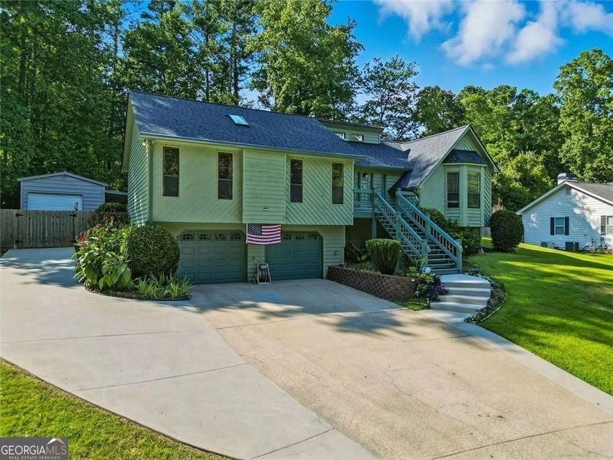 This move-in ready ranch brings a finished basement and a fenced yard you'll actually use. This Woodstock home checks all the right boxes-with room to spread out and a location that keeps you close to Roswell without the hassle.  Inside, the living room welcomes you with a stone fireplace and natural light, setting a cozy tone for the main floor. The kitchen and dining area flow easily from here, creating a practical layout for both daily living and entertaining. Plus, the washer and dryer will stay with the home for added convenience.  The primary bedroom suite offers a private retreat with its own bathroom, while two additional bedrooms share a full hall bath-ideal for guests, family, or a home office setup.  Downstairs, the finished basement adds even more flexibility. Whether you're envisioning a media room, gym, or hobby space, there's plenty of room to make it yours. The drive-under two-car garage offers secure entry and storage, while the separate one-car detached garage is perfect for a workshop or extra vehicles.  Out back, a large deck overlooks the fenced half-acre yard, plenty of room to gather, play, or just relax in peace. A brand-new roof tops it all off, offering peace of mind for years to come.  Plenty of space, both inside and out, in a location that keeps you close to everything-but with the breathing room to enjoy your own corner of it all.