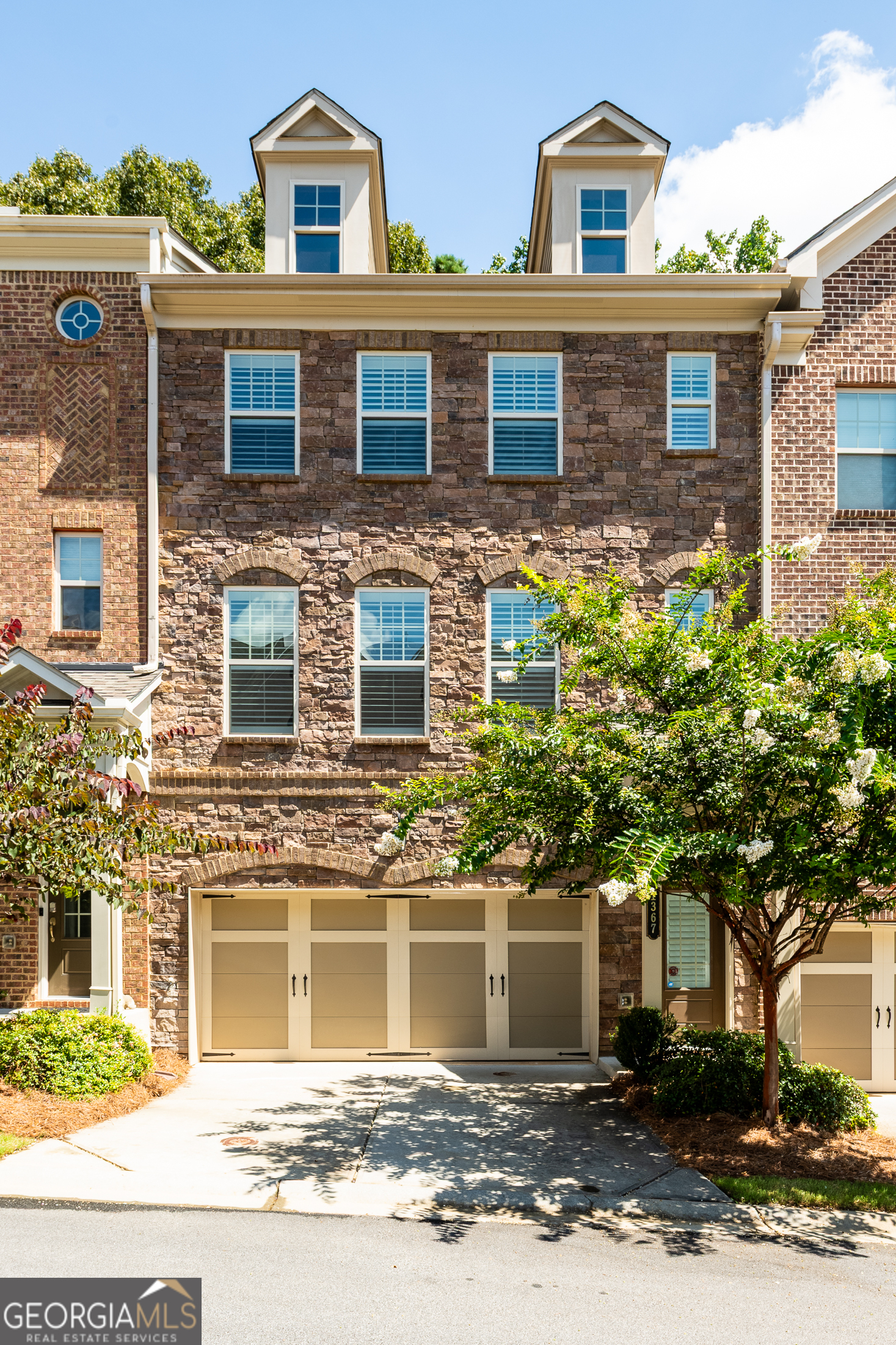 Rare, better-than-new townhome in the gated Townsend at Brookhaven community, offering a unique blend of luxury, functionality, and investment potential. This 4-bedroom, 3.5-bath home stands out with its rare, shady, and fully fenced backyard-perfect for pets, play, or private outdoor living. Inside, the open-concept main level is filled with natural light and enhanced by plantation shutters, designer lighting, and fresh updates throughout, including new paint, plush carpet in the bedrooms, and upgraded flooring on the terrace level. The gourmet kitchen features stainless steel appliances, granite countertops, a large island with seating, and sleek slate-gray shaker cabinetry. A dedicated dining area and spacious living room flow seamlessly to the private back deck, creating an ideal space for entertaining or relaxing. Upstairs, the expansive primary suite serves as a peaceful retreat with a spa-like bath, double vanity, oversized shower, and walk-in closet. Two additional upstairs bedrooms offer versatile space for guests, a home office, or a gym. On the terrace level, a fourth bedroom with en-suite bath and upgraded flooring provides flexible options for roommates, in-laws, or a quiet workspace. Enjoy low HOA dues with no rental restrictions, making this home a great fit for both homeowners and investors. Residents also have access to a community pool through neighboring Evins Walk. Ideally located near Town Brookhaven, Lenox Park, Phipps Plaza, and major highways, 1367 Harris Way delivers exceptional value in one of Atlanta's most desirable neighborhoods. Schedule your private tour today and make this move-in-ready home yours!