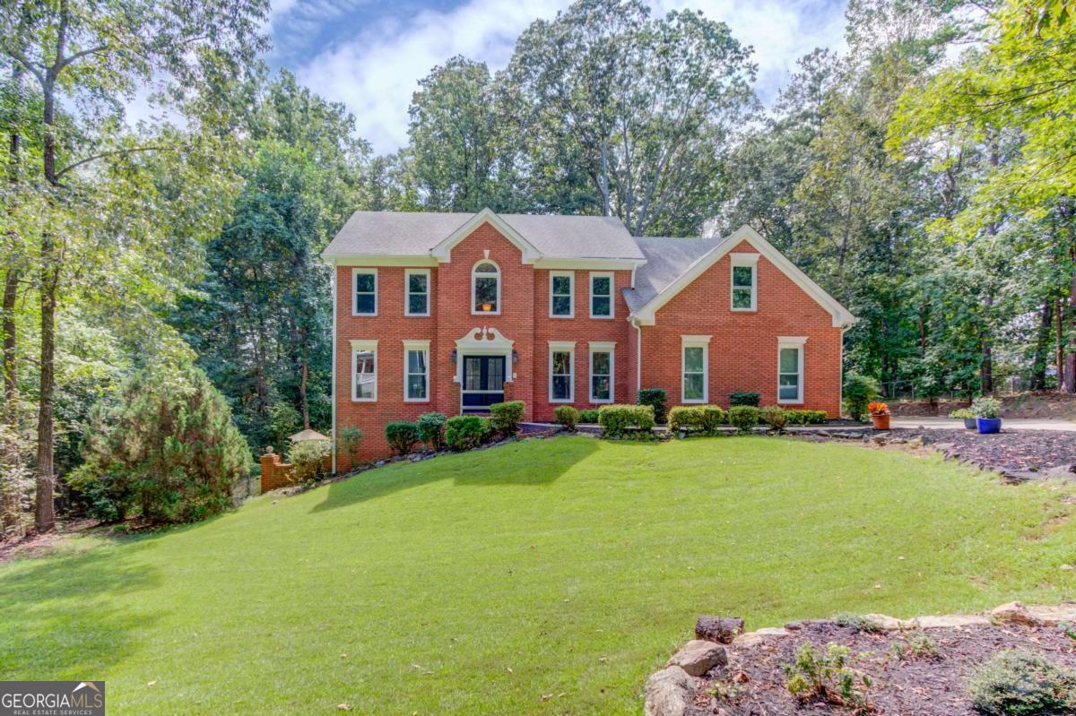 Updated 4-Bedroom Home with Finished Basement on Over an Acre - No HOA! Welcome to this beautifully updated 4-bedroom, 2.5-bath home, ideally located near downtown Sugar Hill, downtown Buford, the Sugar Hill Greenway, and Lake Lanier. Nestled in a quiet suburban oasis, this property perfectly blends timeless traditional charm with modern updates. Step inside through the brand-new water-wave glass front door into a dramatic 2-story foyer with new oak hardwood stairs. New luxury vinyl flooring flows throughout the main level. The inviting layout includes a spacious formal dining room, formal living room, private office, and a fireside family room for cozy gatherings. The newly updated kitchen showcases white shaker cabinetry, granite countertops, stainless steel appliances, and a breakfast area with views of both the family room and the lush, private, fenced backyard. Walk out onto the large brand-new rear deck, perfect for relaxing and entertaining, The oversized primary suite is a true retreat with a tray ceiling, expansive windows, and a spa-like en-suite featuring double vanities, a soaking tub, and an updated separate shower. The partially finished basement offers versatile living space-ideal for entertaining, a media or game room, home gym, office, or workshop. A walk-out patio extends the living area outdoors, providing a second space for relaxation or gatherings. Additional highlights include brand-new insulated sliding windows for energy efficiency and abundant natural light, a 2-car garage, new soffits and fascia, updated electric outlets, hinges, and doorknobs, along with fresh interior paint and crown molding throughout. With countless updates, a prime location, and over an acre of private land, this move-in ready home offers space, style, and freedom-without the HOA!