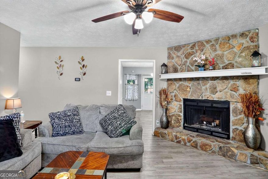 Your Next Chapter Starts Here: Updated Ranch with Character!  ?Step inside this charming and impeccably maintained ranch-style home, where modern updates meet cozy character. The bright and airy living room is the heart of the home, featuring neutral paint, durable wood-look laminate flooring, and an eye-catching stone corner fireplace that provides a perfect focal point and warmth.  ?The kitchen is a chef's delight, boasting sleek white cabinetry, attractive tile backsplash, and a full suite of stainless steel appliances. It's laid out efficiently, making meal prep a breeze.  ?The home offers comfortable living spaces, including a spacious primary bedroom that continues the clean, modern aesthetic with wood-look flooring and a ceiling fan.  ?The exterior features a quaint front porch and is nestled among mature trees, providing a private and peaceful setting. With great curb appeal and a fantastic interior layout, this home is move-in ready and waiting for you! Don't miss the chance to make it yours BUY THIS HOME WITH NO MONEY DOWN!!!!