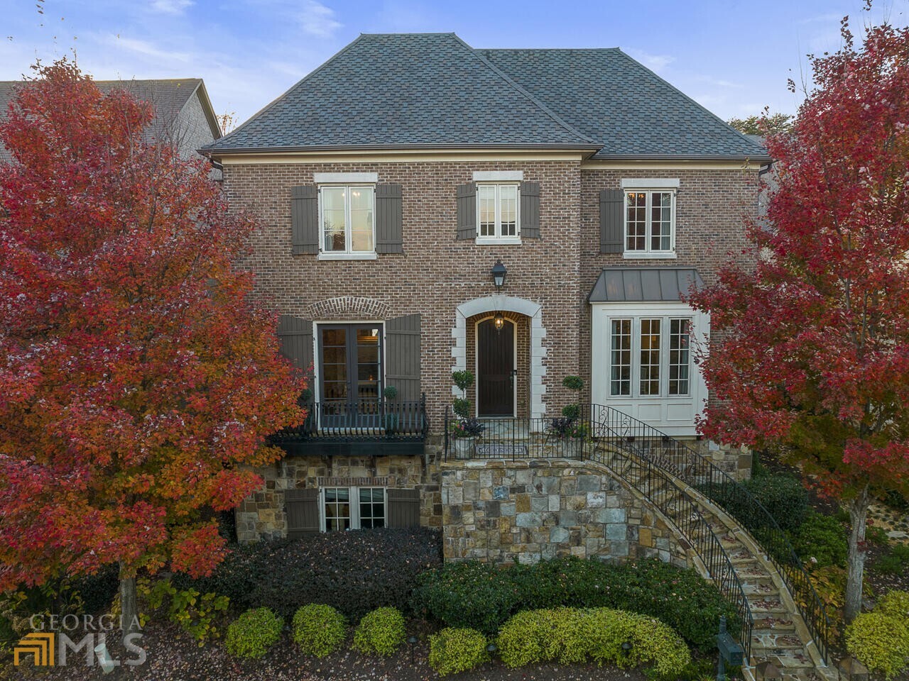 One of Vining's most Sought after Locations that rarely come to market in the Gated Avignon Vining's Village Community. For the most discerning buyer, this home was a custom build by Waterford Homes using the finished level Of finishes and high ceilings throughout. All brick and stone with limestone entry open to grand foyer. Focal point of the formal living room is the Limestone Fireplace surrounded by glass shelf built-in's. Banquet sized dining room to butlers pantry. Old World architecture with modern amenities. Wood burning fireplace in the family room All open to the kitchen, breakfast area and walk out covered loggia area perfect for al fresco dining. Kitchen offers Wolf ovens, gas cooktop, 2 dishwashers, Sub Zero Refrigerator and wine chiller. Elevator and open wide curved staircase to all 3 levels.Decadent owners suite with hidden mirrored TV above fireplace. Dual long vanities, soaking tub and spacious shower. The morning bar from bedroom suite leads to the library with Walk-out stone sitting porch. Full finished terrace level with fitness studio rubber mat flooring, home theater, glamorous wet bar. The detached homes have their own HOA. Steps to Vinings Jubilee.