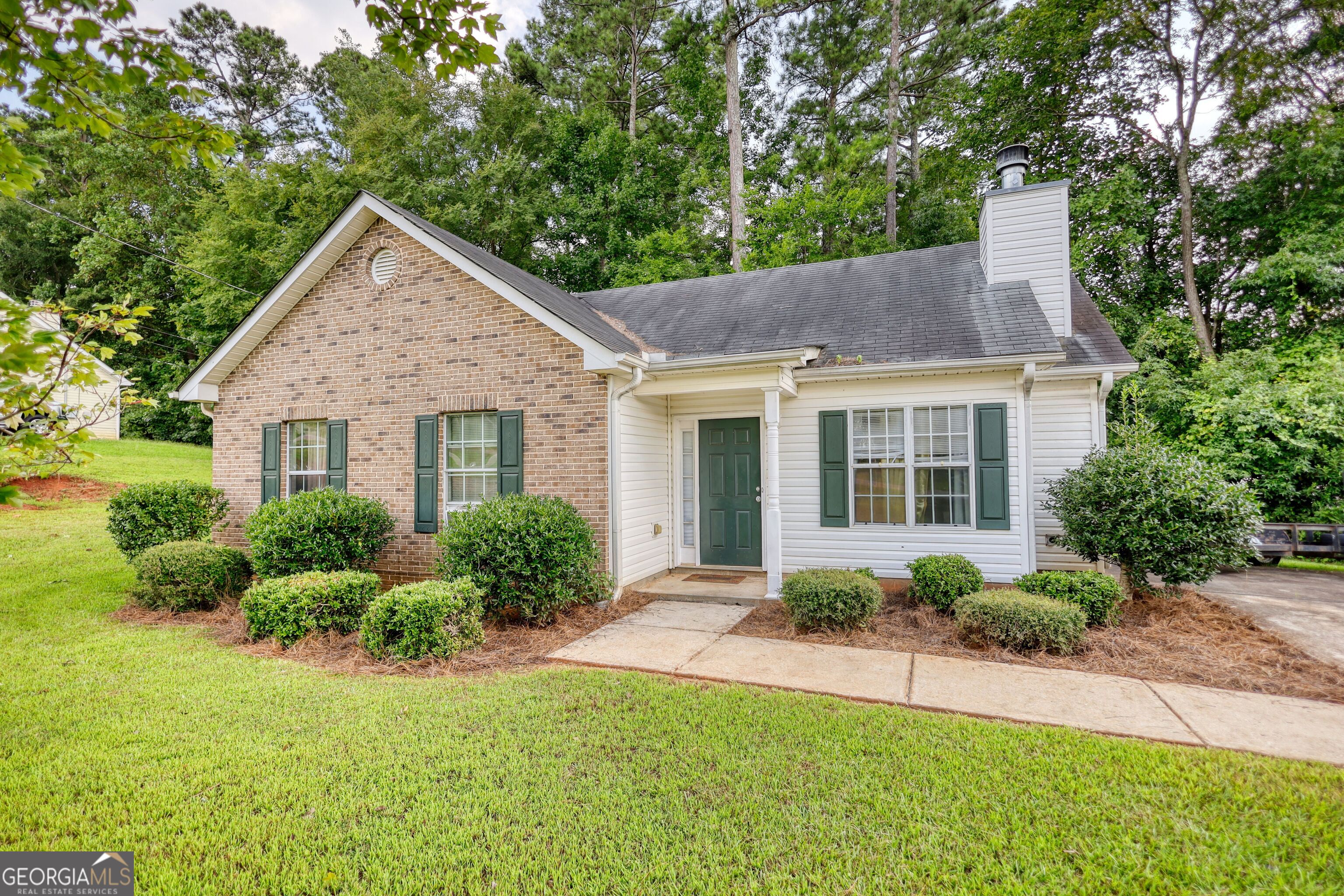 Dreaming of a home off the square in downtown Monticello? This sweet little home is full of potential and ready for new ownership! Entering the home, the family room features a wood burning fireplace and leads into the combination kitchen and dining area. Natural light bathes each room from the large windows and a vaulted ceiling elevates the cozy living room space. A laundry closet is conveniently located off of the kitchen. A short hallway leads you to all three bedrooms and two bathrooms. The primary suite features a trey ceiling and walk-in closet. Just a short distance away, the bustling businesses, farmers markets, and restaurants of the downtown square will ensure you always have something fun to do. Whether you're looking for a starter home, investment property, or are ready to downsize, this home has so much to offer. Please note that some photos are virtually staged and lot lines are approximate.