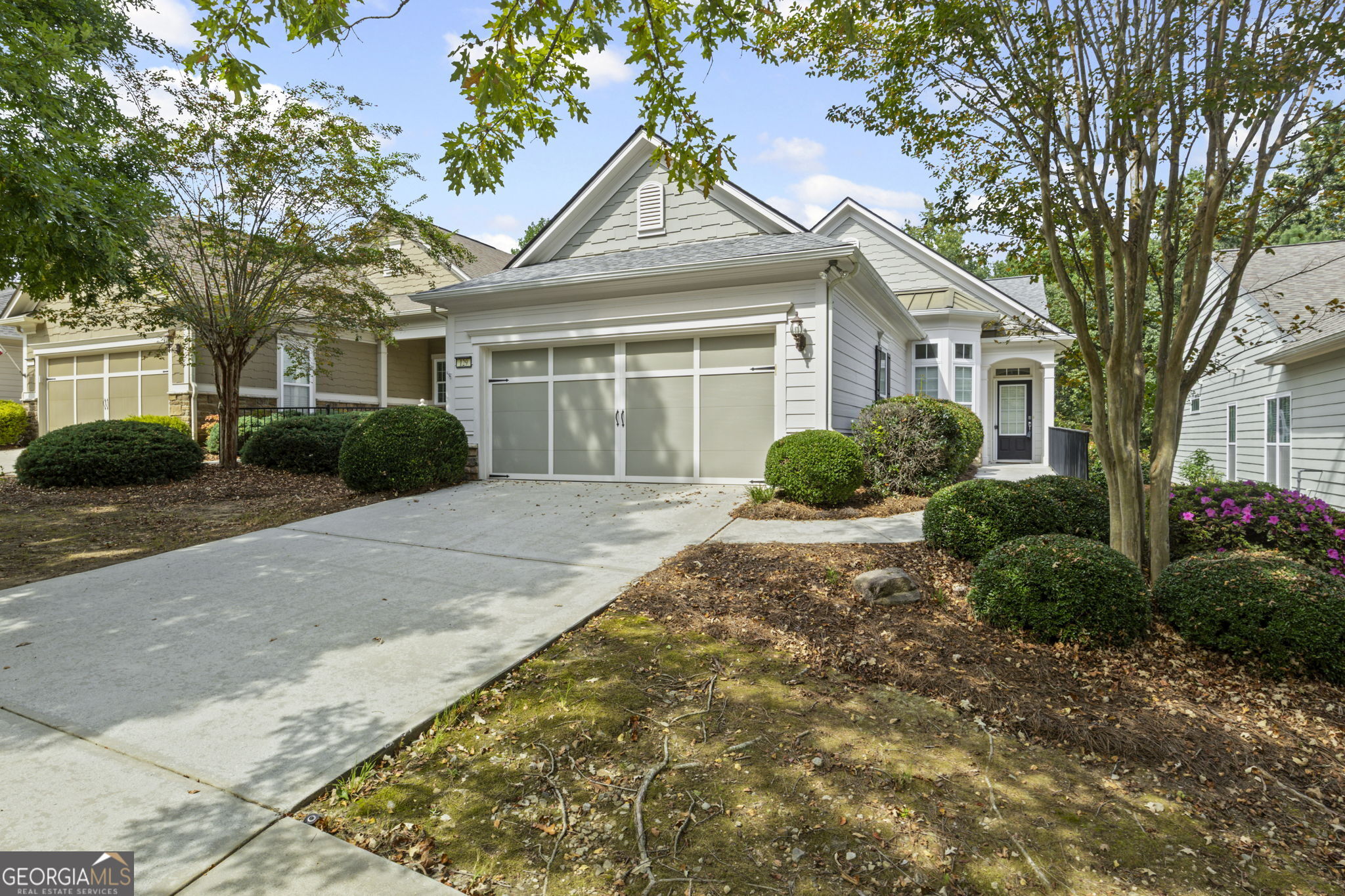 The fun is in full swing in our beautiful fall weather @ Sun City Peachtree. Just listed this very popular plan on a beautiful tree lined street that is very affordably priced and available immediately! This home offers 3 bedrooms, 2 full baths, 3rd bedroom doubles as officedenlibrary. Extensive crown molding throughout. The family room has hardwood floors which flow into the grouted tile sunroom. The kitchen has hardwood floors, granite counter tops and stainless-steel appliances. The master suite has large shower, and double sinks with a walk-in closet. The home features a 4ft ext. garage, sprinkler system and professionally landscaped backyard overlooking a wooded view.