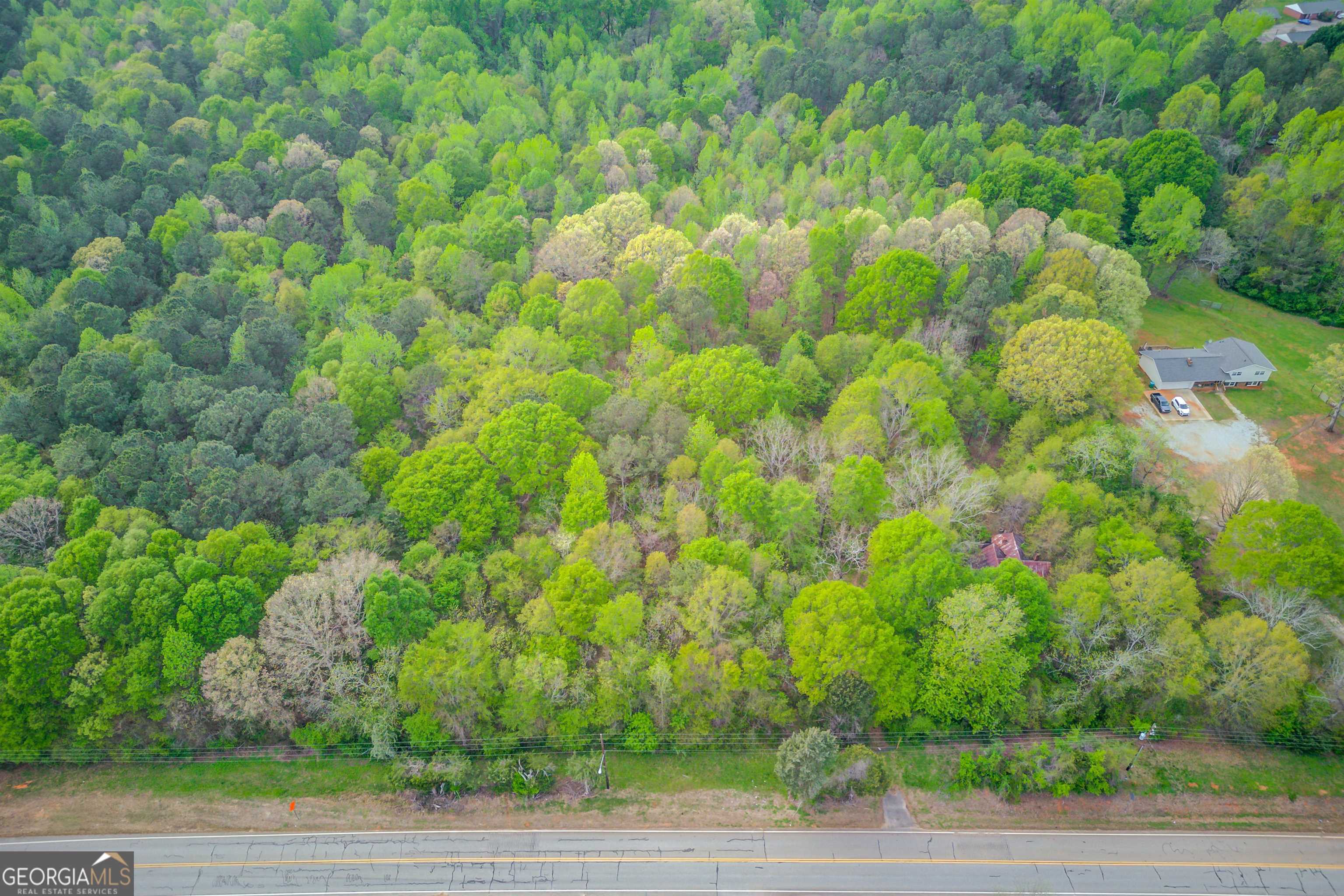 3.95 acres in Jefferson with 449' road frontage on Highway 82 South currently zoned residential in the Jefferson City School District. Please note that there are 3 structures on the property - DO NOT ENTER THE STRUCTURES AS THEY ARE NOT STABLE OR INHABITABLE.