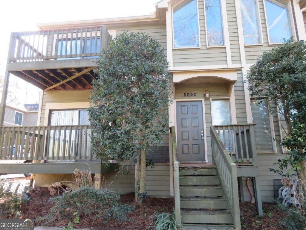 Perfectly located townhome near downtown Alpharetta! Multi-level with tons of natural lighting! Spacious living room with fireplace! Separate dining room! Kitchen features stained cabinets, plenty of counter space, and breakfast area! Half bath on main for guests! Balcony/deck off main! Two bedrooms on upper level each with their own full bathroom! One with walk-in closet! The other with a balcony! Another bedroom and full bathroom on basement level, along with a 2 car garage! Great opportunity! Don't miss out!