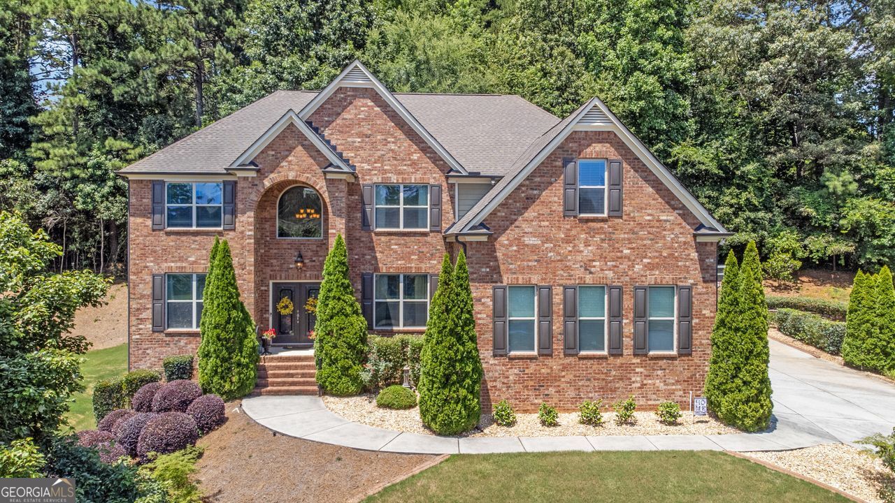 Fall in love with this stunning 5-bedroom home with lake views, located in the highly sought-after Brookwood School District! This 3-sided brick beauty features a 3-car side-entry garage and includes a fully finished basement with an entertaining area, game room, and home gym. Step into the grand 2-story foyer and enjoy brand-new hardwood floors throughout the main level and fresh interior paint! The gourmet kitchen is a chef's dream with granite countertops, stainless steel appliances, double ovens, a gas cooktop, an island, a breakfast bar, a wall-mounted pot filler, a walk-in pantry, and a breakfast room that opens to the spacious family room with a fireplace-perfect for gatherings. Enjoy working from home in the dedicated main-level office and movie nights in the oversized upstairs bonus/media room. The primary suite offers a peaceful retreat with tray ceilings, a custom walk-in closet, double vanity sinks, a soaking tub, and a separate shower. Step outside to your fenced backyard oasis, complete with a retaining wall system that enhances both landscaping and privacy. Located in a vibrant swim, tennis, and lake community, this home truly has it all: space, style, and an unbeatable location!