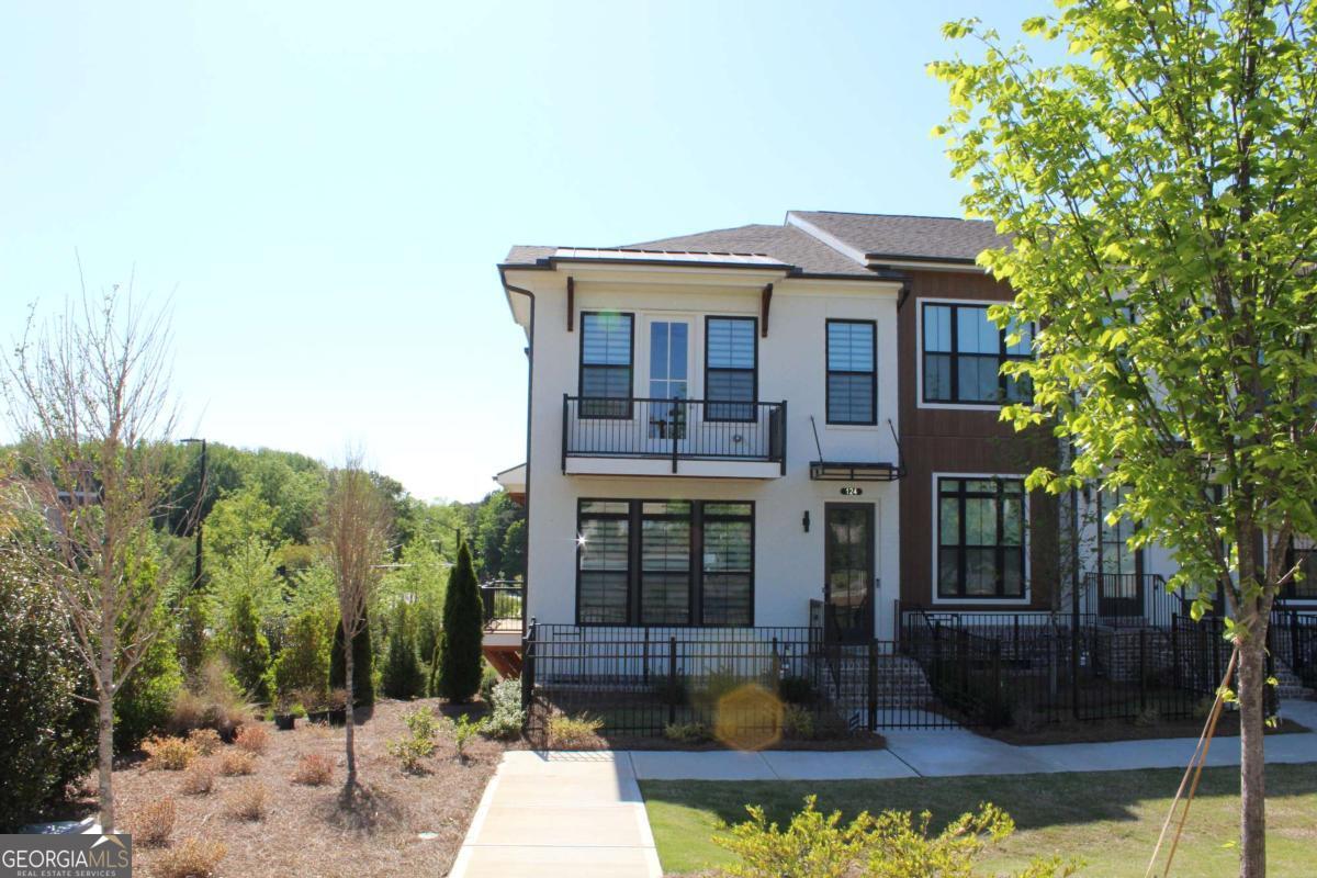 Basically brand new townhome located near Northpoint Mall just minutes away from numerous dining options, retail space, trails, & more! 0.2 miles from the new North Point Redevelopment District, 0.7 miles from the Big Creek Greenway entrance, 1.9 miles from Downtown Alpharetta, 2 miles from Avalon, & direct entrance to the future Alpha Loop Extension. Gorgeously appointed end unit townhome, Gourmet Kitchen with modern features such as MSI Quartz Countertops, Full Overlay Cabinets w/ soft close doors & under cabinet lighting, GE Stainless Steel Appliances, Walk-In Pantry. Main Level offers a more! Behind the Kitchen you will find a Sunroom, perfect for an office or separate dining space w/ entry to the deck + half bath, & two separate storage closets. Kitchen Island overlooks the open concept Dining & Living Room. Centered in the Living Room is a contemporary linear fireplace. Excellent roommate floorplan with 2 beds and 2 baths upstairs. Oversized Owner's Suite with tray ceilings and large walk-in closet, bathroom includes dual vanities, linen closet, spacious shower w/ frameless door, modern freestanding tub & separate shower. Terrace level with bedroom, full bath & spacious walk-in closet.
