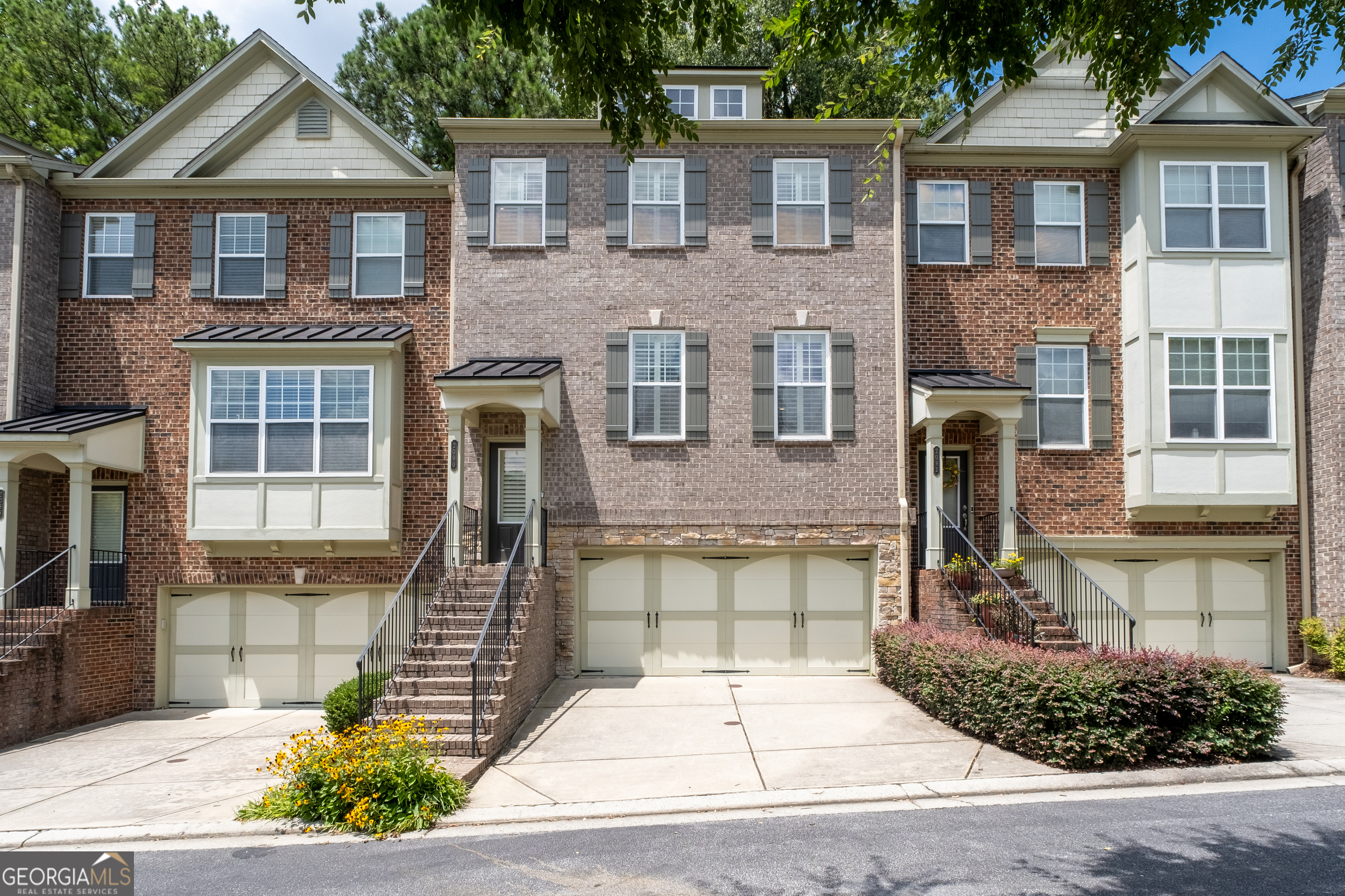 Welcome to 2090 Cobblestone Way Where Practical Living Meets Unexpected Charm! Tucked within a highly desired gated community, this three-story townhome is over 2,500 square feet and offers a surprisingly spacious layout that balances comfort with everyday function. Featuring three well-proportioned bedrooms each with its own en-suite bath. The expansive main level invites you in with warm hardwood floors, a cozy gas fireplace, and a kitchen that, while tastefully finished with granite counters and stainless steel appliances, offers even greater potential when experienced in person. The layout flows naturally to a private deck, a serene space for quiet mornings or casual evening gatherings. Upstairs, the oversized primary suite provides a quiet escape, complete with an extra versatile sitting area, tray ceiling, and a generously sized bathroom designed for comfort. Two additional bedrooms, the dining room, and the patio leave space for everyone! While exterior upkeep is handled for you, the real value lies in the quiet pride of ownership throughout the community. With easy access to I-85, GA-400, I-285, Buford Hwy and Peachtree, you are always connected. Minutes from Buckhead and walking distance to the local charm of Brookhaven, you are guaranteed to enjoy daily living in Cobblestone at Brookhaven!