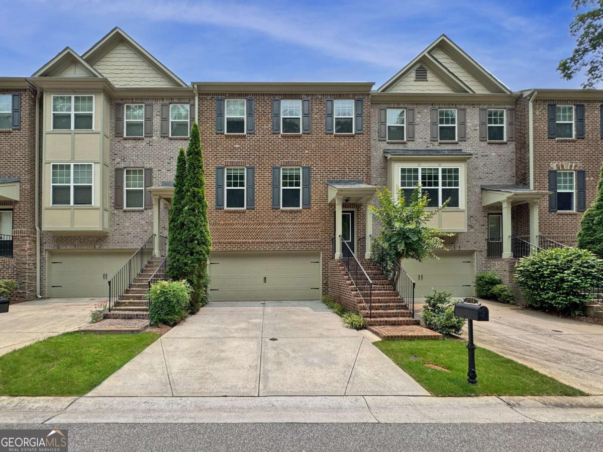 Location! Location! WELCOME HOME to this beautiful 4 bed, 3.5 bath brick-front townhome in Danbury Parc, located in the heart of Brookhaven! Positioned on a quiet secondary street in the community, this home boasts an open floor plan with low-maintenance, kid/pet/life-friendly LVP flooring on all three levels! The main living level includes a spacious fireside family room, open dining area, half bath, and an eat-in kitchen complete with a breakfast bar, granite countertops and stainless appliances, as well as an adjacent breakfast area. Upstairs, you'll find two spacious guest bedrooms, guest bathroom, and the oversized primary bedroom with tray ceiling, and ensuite bath with double vanity, walk-in shower, separate soaking tub, and walk-in closet. The lower level includes a sizable guest bedroom, full guest bathroom, and the 2-car garage with epoxy floors and convenient storage rack hangers and cabinetry! A rear balcony/deck on the main level and patio on the lower level provide great spaces for outdoor entertaining or just relaxing. Danbury Parc amenities include a swimming pool, dog park, and fire pit common area, with HOA-covered exterior structure maintenance, termite control, lawn/grounds maintenance and trash service. Just steps from public parks, grocery shopping, restaurants and more! Homes in this community don't come on the market often, hurry and schedule a showing today!