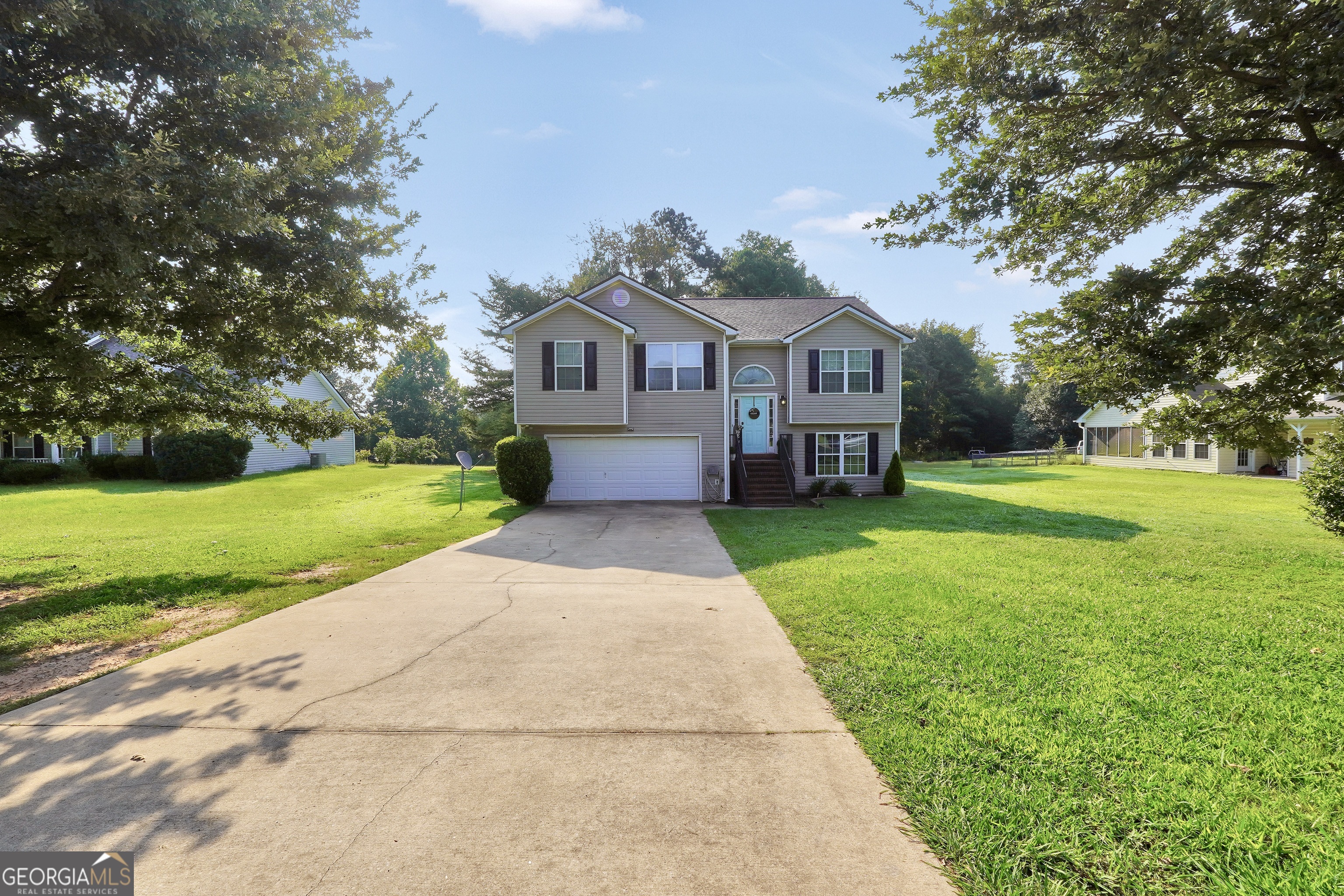 Don't miss this 5-bedroom, 3-bath split-level home nestled on a quiet street with a fully fenced backyard-perfect for outdoor living! The main level features a large living room with cozy fireplace, separate dining area open to the living space, and a galley-style kitchen with a sunny eat-in nook. The spacious primary suite offers vaulted ceilings, a large walk-in closet, and a private bath with dual vanities, garden tub, and separate shower. Two additional bedrooms and a full bath complete the main floor. The fully finished lower level includes two more bedrooms, a full bath, and a flex room-ideal for a home office, playroom, or gym. A large 2-car garage offers plenty of storage. This home has space for everyone, inside and out. Schedule your showing today!