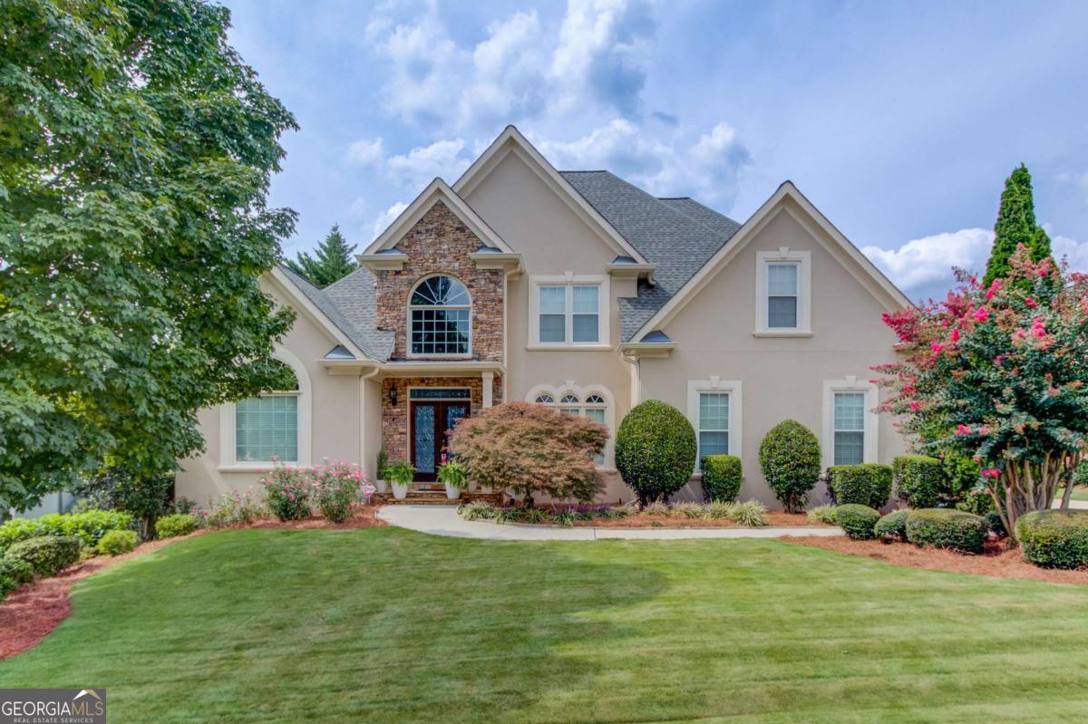Located in the highly sought after Hamilton Mill community, this 6 bedroom, 4.5 bath home offers stunning golf course views of the 10th green and 11th tee box.The spacious open floor plan is filled with natural light, featuring a two story foyer, separate dining room, and private office.The owner's suite is conveniently located on the main level. Enjoy multiple gathering spaces with fireplaces in both the main living room and the finished basement family room. The terrace level is fully finished, offering endless options for entertaining, recreation, or guest space. Outside, the beautifully landscaped yard provides a serene backdrop for golf course living.Hamilton Mill residents enjoy resort style amenities including two swimming pools, tennis and pickleball courts, sidewalks, streetlights, a swim team, golf course, and clubhouse all within the top-rated Mill Creek school district.