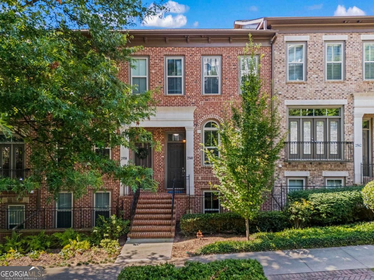 Prepare to be the most popular friend on every game day! This is the home you have been waiting for with endless entertainment opportunities without even having to turn your car on! The Towns of Crescent Park gated community offers a private, secure, and beautiful atmosphere that is WALKING DISTANCE from Truist Park and everything that The Battery has to offer. From watching the Braves win another world series, to concerts at the Roxy, to numerous retail stores, restaurants, and bars - you will never be short of activities to enjoy! When you're done with your night out or looking for a night in, you can enjoy the peaceful closely knit community with incredible neighbors. 2560 Crescent Park Court offers a prime placement on the front of community with a beautiful brick-front curb appeal and sidewalks lined with matured trees & manicured landscaping making your daily walks a dream. You'll be stunned as you enter the main level featuring 10-foot coffered ceilings, site-finished hardwood flooring, floor to ceiling windows beaming with natural light, a beautifully finished kitchen that is open to the living area with custom built-in cabinetry, and a separate dining room/office/study. The spaciousness and natural light that this home provides is unmatched. The hardwood flooring extends throughout the home as you venture upstairs to the large primary & secondary bedroom, both with private, en-suite full bathrooms. I cannot stress enough how HUGE the primary bedroom is and the trayed ceiling just adds to the spacious, cozy feel in the room with natural light beaming through the large rear windows. Enjoy the spa-like primary bathroom with a double-vanity, separate shower/tub, private toilet room, and large walk-in closet. On the lower level, you'll find a beautifully finished large bedroom with another en-suite bathroom offering the perfect space for an in-law suite/roommate scenario. This home is the entertainers dream with the open concept & rear patio off of the living room where you'll be able to watch the stadium fireworks! RUN, don't walk, to see this stunner in person and begin imagining your new life in this amazing community!