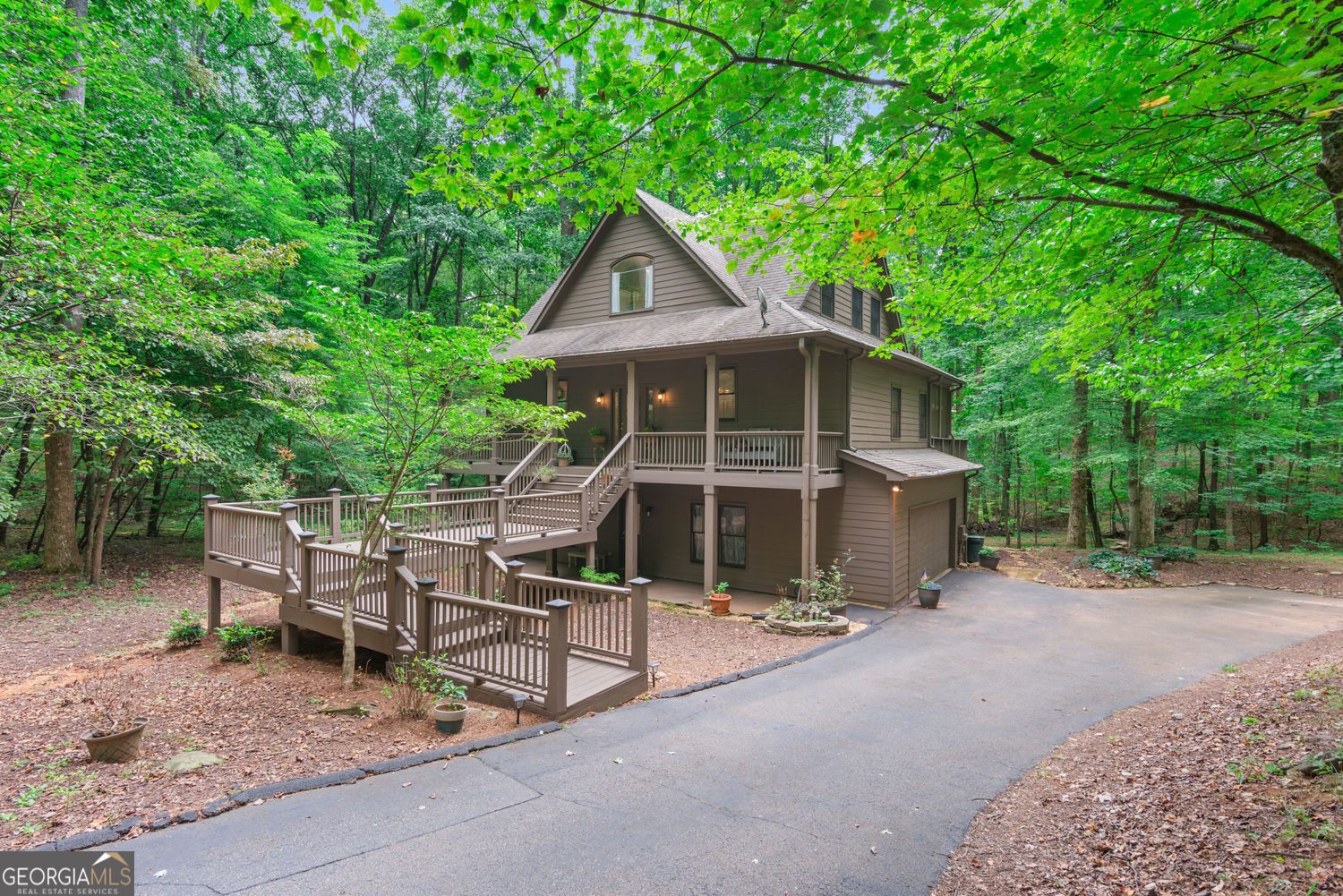Enjoy the beauty of this elaborate Three Story Custom Built Home in the Heart of the Gated Community of Big Canoe its's the perfect blend of modern comfort and natural charm that offers 3,471 sq ft of tranquil living area with 3 spacious bedrooms, 3 full bathrooms, and 1 half bath, tucked away on 1.6 acres of serenity. Step inside to discover an open concept living area that features genuine hardwood floors, a cozy handcrafted stone fireplace, soaring views from the floor to ceiling windows capturing nature at its finest. The Kitchen is stunning with gorgeous quartz countertops, over 10ft kitchen island, built in wine rack, bar seating, farmhouse sink, new stainless-steel appliances, elegantly crafted cabinets, a breakfast area that makes this the ideal place for Family and Friends. An oversized Primary Suite on the Main, which includes its own private access to a screened in porch, great for enjoying your morning coffee or for unwinding into the evening twilight. Upstairs you'll find a versatile flex space, bedroom with a full bath, a loft overlooking the main level ideal for a home office or a playroom with a cozy reading nook. The lower level boasts as either an in-law suite or a teen retreat, complete with new luxury vinyl plank flooring throughout giving it a modern spin, a separate living area with a coffee bar & wet bar with access to a screened in porch and large patio area. Step outdoors into an oasis, on the large outside deck which is perfect for Hosting all outdoor gatherings and events. Take a walk into your backyard and escape into nature featuring a private creek and beautiful hiking trails to walk and explore. Homeowners also enjoy access to exceptional community amenities, including three lakes for boating, kayaking and fishing a marina, and multiple swimming pools, a wellness center, hiking trails, dog parks, playgrounds, tennis courts, pickleball courts, racquetball along with a championship golf course Come make this Home Your Own!