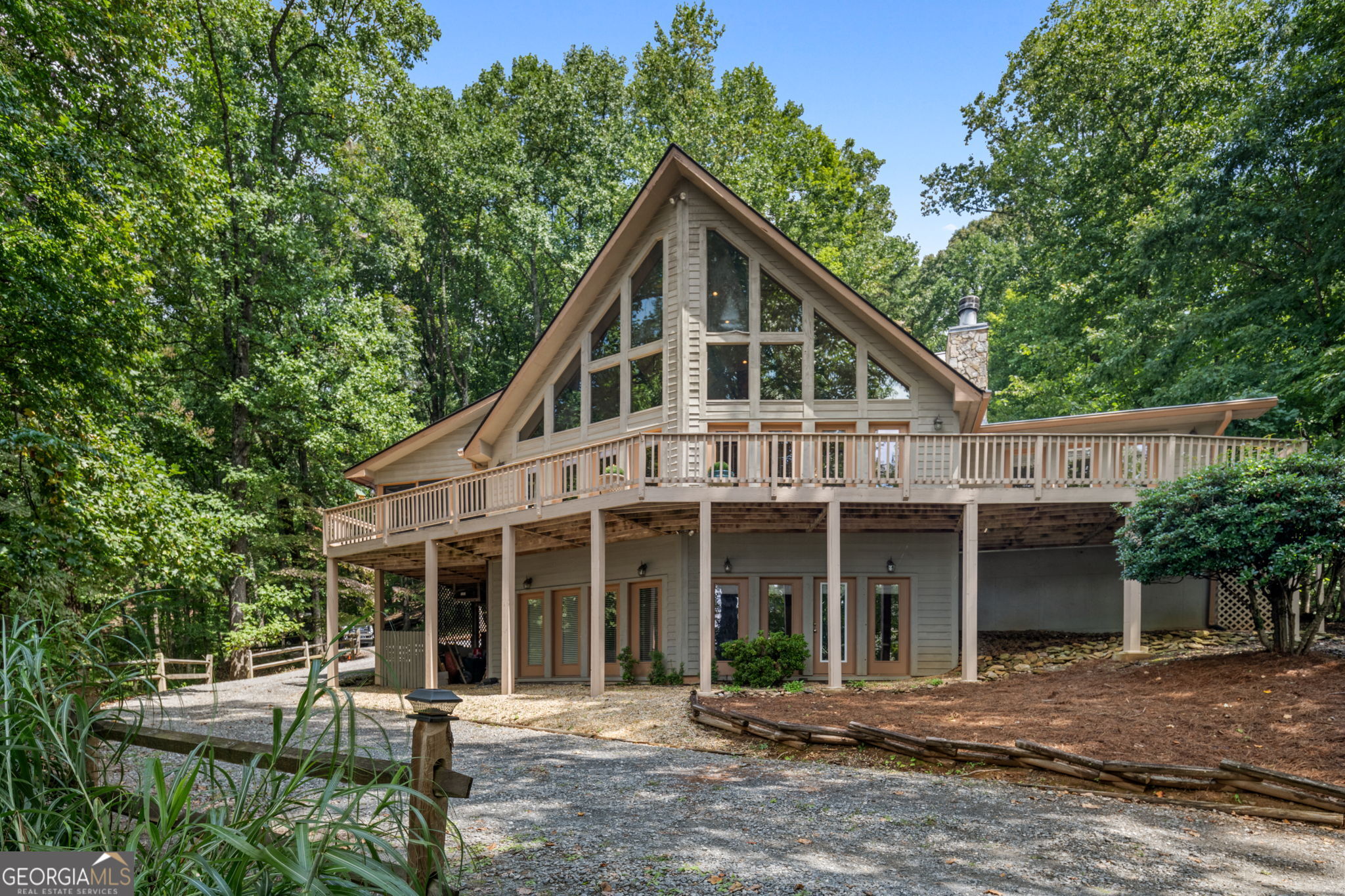 Welcome to 233 Soquili Trail in the desirable Hickory Cove community of Jasper. Nestled on 2.46 private acres, this immaculate home offers unbelievable long-range mountain views and breathtaking sunsets that define North Georgia living. This multi-level, open-concept home with upper-level bedrooms and bonus space features 3 bedrooms plus an office (easily converted into a 4th bedroom) and 3.5 bathrooms. The finished terrace level is a complete in-law or teen suite with its own private entry, ideal for multi-generational living, extended guests, or private rental space. Step through the beautiful open foyer and be greeted immediately by mountain views, creating a dramatic and inviting first impression. The heart of the home is the open-concept family room, anchored by a stacked-stone wood-burning fireplace, which flows seamlessly into the family dining area and the gourmet kitchen. The kitchen features custom cabinetry, granite countertops, a walk-in pantry, stainless steel appliances, ample prep space, and a large breakfast bar, perfect for both entertaining and everyday living. A spacious laundry room adds functional convenience. The primary suite is a true retreat, complete with a gas fireplace and expansive windows framing the mountain views. Outdoor living is exceptional, with a spacious screened-in porch perfect for year-round enjoyment and a large deck overlooking the mountains, providing multiple ways to relax and entertain while enjoying the natural surroundings.