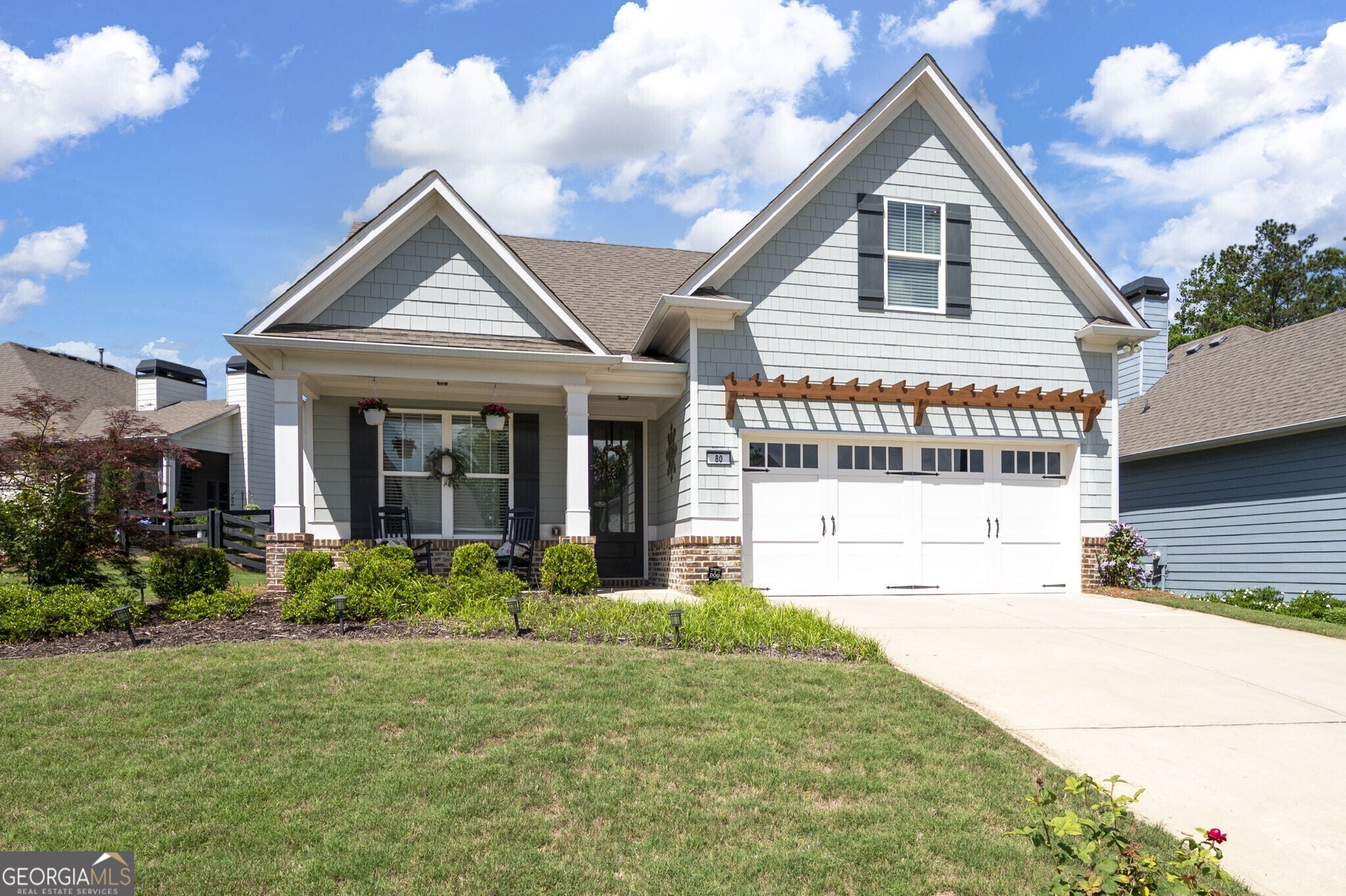 Welcome to Stratford at NatureWalk, an exceptional 55+ active lifestyle community! This charming craftsman-style ranch home features 3 bedrooms and 2 baths, set on a lovely lot with a welcoming covered front porch. Step inside to find soaring ceilings, gleaming hardwood floors, and a warm, inviting entryway. The open concept floor plan flows seamlessly into the dreamy kitchen, which boasts a large two-tone island, white cabinetry, stylish backsplash, granite countertops, stainless steel appliances, and a cozy eat-in area. The laundry room is conveniently located just off the kitchen. The fireside family room is the perfect spot to relax, complete with plantation shutters. Step outside to the vaulted screened porch, featuring epoxy-coated flooring, where you can unwind year-round while enjoying views of the beautifully landscaped, fenced backyard. The master suite on the main level features tray ceilings and separate his-and-her walk-in closets. The luxurious ensuite bath includes a tile-surround shower and dual sinks. The main floor also offers a guest room, a full bath, and an epoxy-coated 2-car garage. Upstairs, you'll find a spacious 3rd bedroom with a walk-in closet, along with ample attic space for all your storage needs. As a resident of Stratford, you'll enjoy a low-maintenance lifestyle surrounded by nature and a wide range of exceptional amenities, including: adult-only clubhouse & pool, pickleball & tennis courts, a full-time lifestyle director, miles of nature trails, golf cart paths, a dog park, junior-olympic pool, basketball & volleyball courts, and more! In addition to the exclusive adult-only amenities at Stratford, you'll have access to the full suite of award-winning Seven Hills amenities. Stratford's active-adult community is highly social, with regular Friday night get-togethers, Bunco, a book club, monthly luncheons, weekly men's golf outings, to name a few. Located in a highly sought-after area, this community offers easy access to dining, shopping, recreation, and healthcare facilities. Plus, with landscaping and trash services covered by the HOA, you can spend more time enjoying all the perks this home and community have to offer! **Reduced Costs Option: With Preferred Lender, receive up to $2500 credit toward closing costs OR Temporary 1-Year Buydown.