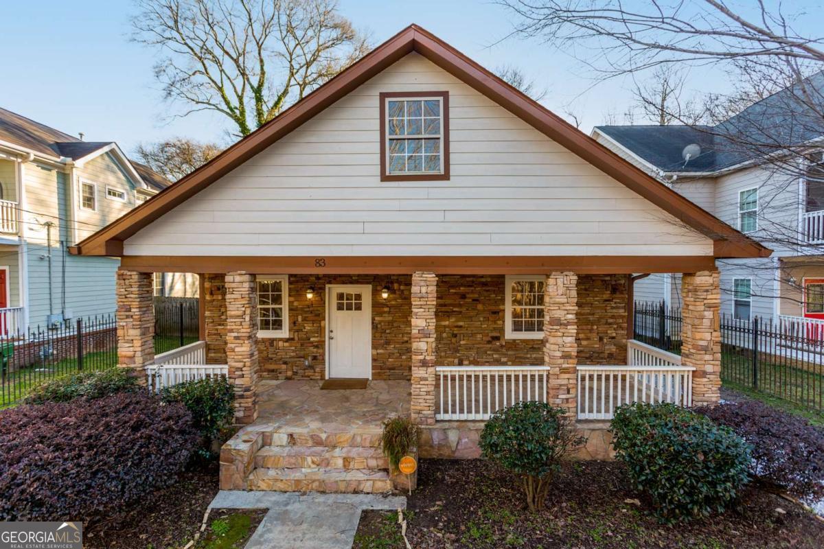 Spacious 5-Bedroom Home on a large lot in the Summerhill/Grant Park area! Welcome to this beautifully maintained home on a large lot in one of Atlanta's most vibrant and up-and-coming neighborhoods - Summerhill. Just steps from the acclaimed Talat Market and minutes from Georgia Avenue, downtown, Grant Park, 1-75/85 I-20 access and the Georgia State Stadium, this home offers the perfect blend of space, charm, and location. Enjoy the outdoors year-round with a newly added back deck (2021) - ideal for grilling, entertaining, or relaxing in your large, fully fenced backyard. The front yard is also gated, creating a perfect environment for pets to roam freely. A gated driveway fits up to 3 vehicles, with plenty of additional street parking available. Inside, you're greeted by a covered front porch that opens into a large, light-filled living and dining area. The kitchen features stainless steel appliances, granite counter tops, and a picture window overlooking the large backyard. The primary suite is located on the main level and includes a private en-suite bath and direct access to the full length, back deck. An additional bedroom and full bath are also located on the main floor. Upstairs, you'll find three spacious guest bedrooms, a third full bath, and a versatile bonus room perfect for a playroom, office, or media space. Just before the bonus room is a large, open flex space ideal for an upstairs living area, workout area or play space. Other highlights include: Hardwood floors throughout, a dedicated laundry closet with W/D hookups and ample attic storage space. Don't miss your chance to own a large, move-in-ready home in a rapidly growing community with unmatched walk-ability and charm!