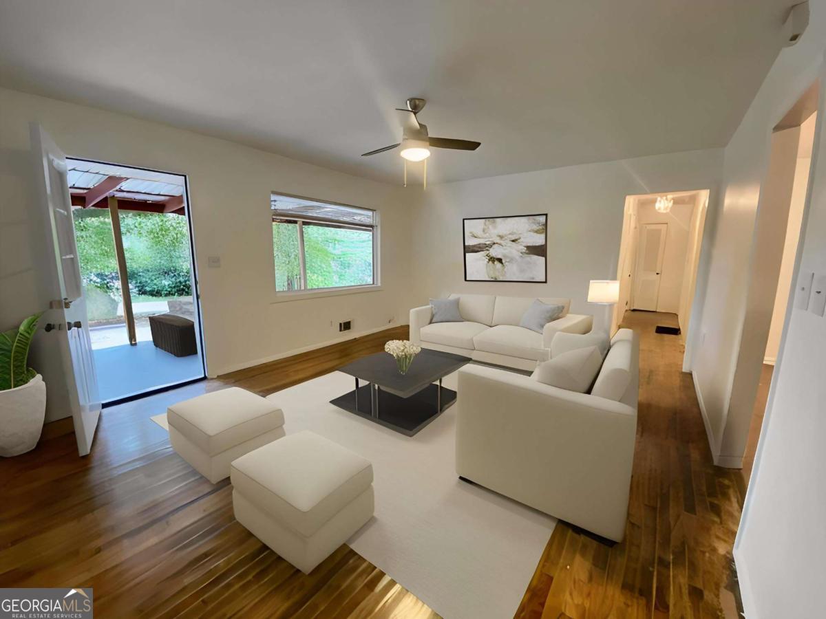 Beautiful renovation of this sprawling ranch home sits on a quiet tree-lined street. Original hardwoods have been restored to their original glory with matching Luxury vinyl plank in kitchen, dining and master suite. Large living room and separate dining room with new luxury LED lighting and fan. Kitchen has stainless appliances with beautiful quartz countertops and deep sink. Master suite spans the length of the house with a fireplace, access to the backyard and en suite bathroom. Master bathroom comes with gorgeous soaking tub and luxurious lighting. Other three bedrooms are on the other side of the living room. Two of the bedrooms share the renovated hall bathroom with brand new shower and the third bedroom has its own half bathroom. Hardwood floors throughout the bedrooms. Roof is less than 1 year old! Plenty of parking in the large driveway and no neighbors across from you for beautiful views of just trees from your front porch. Large fenced yard is ready for any plans you have for it. Location is great - close to shopping, grocery and just minutes from I-285 plus a short drive to Decatur Square, East Atlanta Village, Emory and the CDC.