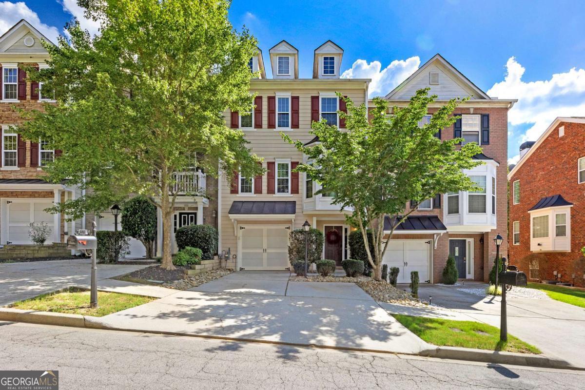 Welcome to this immaculately kept townhome, perfectly located in a beautifully maintained community within a top-rated school district! This spacious and inviting home features generously sized bedrooms, each with its own private bathroom - with new countertops in all secondary bathrooms for a modern touch. The serene master suite offers a double vanity, soaking tub, and a separate tiled shower for a spa-like experience. The thoughtfully designed kitchen is a true showstopper, featuring a large, eye-catching island with plenty of cabinet space, including storage beneath the island, a stylish coffee/bar nook, and gleaming hardwood floors throughout the main level. French doors open to a private deck - perfect for enjoying morning coffee or hosting guests. Additional highlights include brand-new energy-efficient windows installed just one year ago, backed by a 20-year transferable warranty - a valuable upgrade for future peace of mind. Enjoy access to resort-style community amenities such as swimming, tennis, pickleball, and scenic walking trails. Conveniently located within walking distance to Fresh Market, popular restaurants, and just minutes from Suwanee Creek Park. This move-in-ready home is the perfect blend of modern upgrades, thoughtful design, and unbeatable location - a true gem waiting for its next owner!