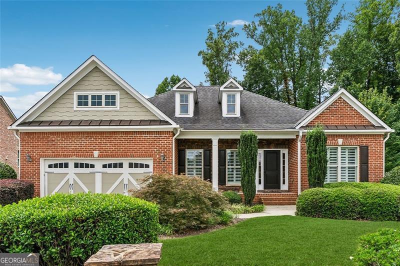 One-story living has never looked better in this gorgeous Cumming ranch-a four-sided brick beauty with a basement brimming with potential! Beautiful rich hardwoods flow through the main living area, paired with a bright neutral palette that radiates warmth. Elegant wainscoting and refined trim throughout will delight you, adding a touch of timeless charm. The expansive chef's kitchen overlooks the living area and shines with stainless appliances, gleaming granite counters, a gas cooktop, and a large island, ideal for whipping up your favorite meals or hosting festive get-togethers. The open-concept living area, accented by a stunning fireplace and custom built-ins, creates a positively chic space perfect for lively gatherings or quiet evenings at home. Owners have the option to join the adjacent Polo Golf and Country Club offering golf, clubhouse dining, tennis, pickleball, family and adult pools and access to the Big Creek Greenway. An exceptional lifestyle is offered in this highly sought after gated community. Don't miss this opportunity, call today for your private showing!