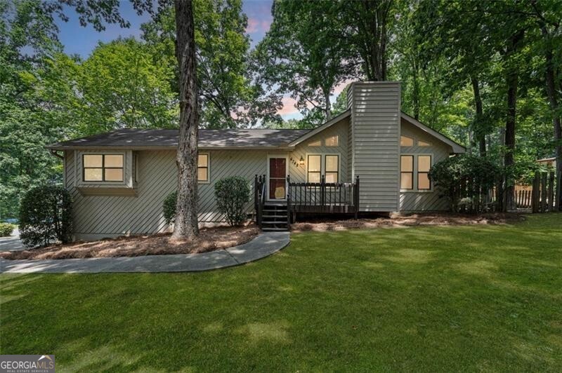 Classic East Cobb Charm with Modern Touches. Welcome to this timeless 4-bedroom, 3-bathroom gem nestled on a beautifully landscaped corner lot in sought-after East Cobb. From the moment you arrive, the inviting front porch sets the tone for the warmth and comfort found within. Step inside a welcoming foyer that opens to a spacious, light-filled family room-perfect for relaxed mornings or cozy evenings. The elegant dining room, framed by classic French doors, flows seamlessly into a cheerful sunroom, ideal for enjoying your morning coffee or curling up with a good book. The updated kitchen is both functional and stylish, featuring stainless steel appliances, granite countertops, and plenty of cabinet space for all your culinary needs. On the main level, the primary suite offers a private retreat with its own en suite bath, while two additional bedrooms share a beautifully renovated hall bath. Downstairs, the finished basement expands your living space with a fourth bedroom, full bathroom, and a large entertainment or game room-ideal for movie nights, guests, or a home office. Step outside to a generous backyard oasis with a deck for al fresco dining and a fire pit area perfect for gathering under the stars. Located just minutes from top-rated schools including Lassiter High School, shopping, dining, and parks-this is East Cobb living at its finest. Schedule your tour today and fall in love with your next home!
