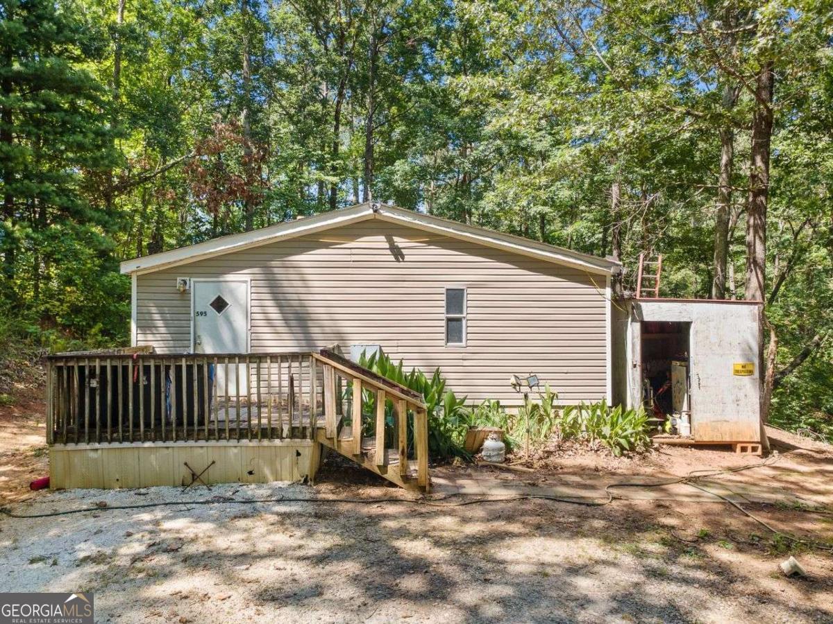 Nestled on a spacious 1.29-acre lot, this 3-bedroom, 2-bath home offers the perfect blend of privacy, potential, and proximity to town. Located just a short 20-minute drive from downtown Dawsonville, this property is ideal for those seeking a peaceful retreat with room to grow. Inside, you'll find a functional layout with great bones, ready for your personal touch. Whether you're a first-time buyer looking to build equity or an investor searching for your next project, this home is full of opportunity. The generous lot provides ample space for gardening, outdoor entertaining, or even future expansion. While the home does need a little love, it's a rare find at this price point with acreage in such a desirable location. Bring your vision and make this house your own!