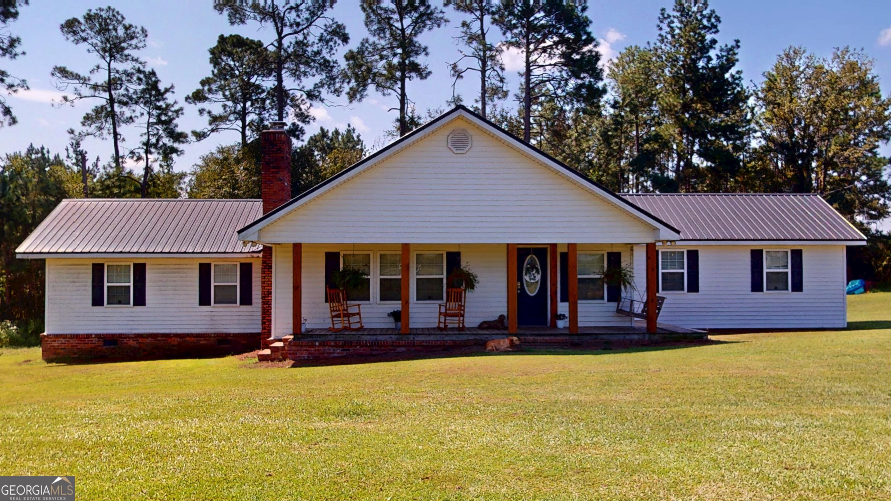 Escape to the country with this unique property offering nearly 10 acres of peaceful living, yet conveniently located close to town. The home boasts three bedrooms, two full bathrooms, and a half bath, providing ample space for family and guests. A standout feature is the two large living areas, with one offering incredible flexibility - perfect as an extra bedroom, playroom, crafting room, or even a home office. The modern kitchen is large, with stainless steel appliances, a breakfast nook, and a center island. It is fantastic for family dinners or entertaining friends. Off the back of the kitchen is a large mudroom/pantry that provides lots of storage. Outside, you'll find a tranquil one-acre pond with a covered dock, ideal for fishing or enjoying breathtaking sunsets. This property truly has something for everyone, offering a serene retreat and a chance to embrace country living at its finest.