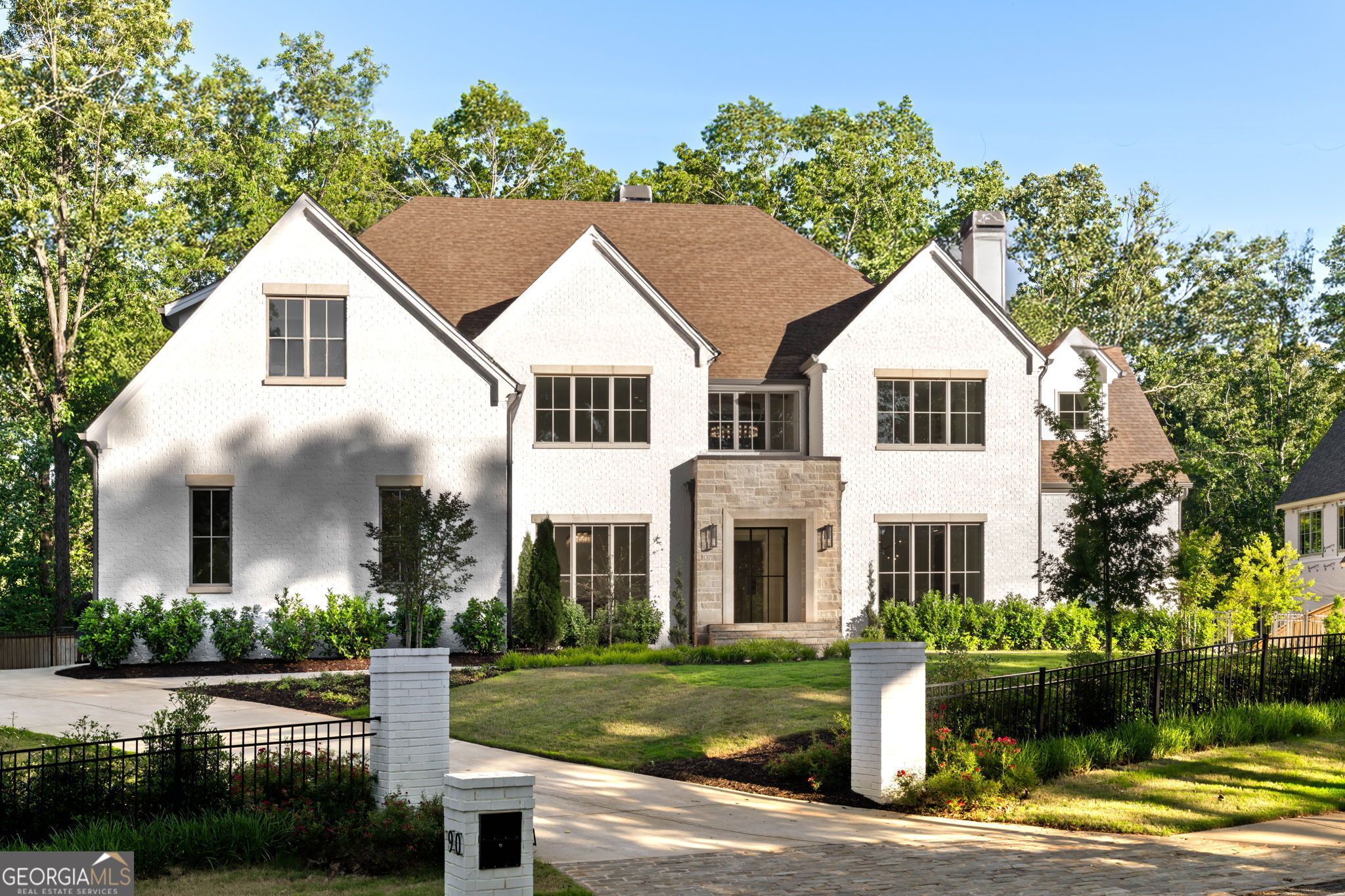 Chastain Elegance, presenting a stunning 6-bedroom, 6.5-bath estate that spans a remarkable 9,854 square feet, epitomizing opulent living, meticulously designed by 37th Burleigh Interiors. Upon entry, you are greeted by grand, soaring ceilings that usher you into an elegantly designed open-concept living area bathed in natural light. At the heart of this residence is a gourmet kitchen, showcasing premium Wolf appliances and a Sub-Zero refrigerator-an ideal setting for the discerning chef. The main-level owner's suite offers unrivaled comfort with its spa-inspired ensuite, adorned with luxurious finishes and custom-built his-and-her closets. The impressive 20 foot ceilings enhance the sense of openness and tranquility. Step outside to a serene private retreat, featuring a walkout pool surrounded by travertine hardscape and lush, meticulously landscaped grounds-perfect for both relaxation and sophisticated gatherings. Upstairs, discover four generously sized bedrooms, each featuring its own private ensuite, ensuring both comfort and privacy for family and guests. The home's architectural splendor is evident in its beautifully crafted arches and detailed fluted elements, reflecting exceptional craftsmanship throughout. The lower ancillary level reveals a wine cellar, state-of-the-art home gym, a cutting-edge theater with suede wall coverings, room for billiards or a golf simulator, and an additional bedroom and bath. A Control 4 system integrates seamless audio and visual convenience across the home. Located within the esteemed Jackson Elementary district and just minutes from Buckhead's finest shopping and dining, as well as within jogging and golf cart distance of Chastain Park, this residence represents the pinnacle of luxurious living. Schedule your private tour today and experience this unparalleled opportunity for yourself.