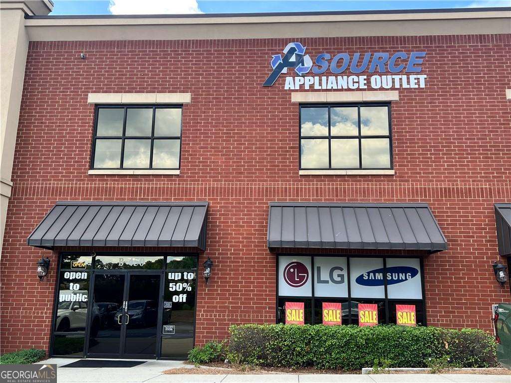 Incredible Flex Condo in Prime Duluth Location - Office, Retail, Warehouse Ready - Don't miss this rare opportunity to own a high-quality, 4,014 SF flex space in the sought-after business corridor of Duluth. Located just off Pleasant Hill Road near Buford Highway and I-85, Unit 450 at 2730 N Berkeley Lake Rd NW offers unbeatable access, visibility, and versatility for your business or portfolio. The main level features approximately 3,034 SF of open-use space with tall ceilings, roll-up drive-in access, and finished areas suitable for retail, showroom, light industrial, or warehousing. The second-floor mezzanine adds an additional 974 SF of built-out office space with large windows, private offices, and open areas filled with natural light-ideal for administrative operations, meetings, or creative teams. Dock is level and a 53" foot truck can enter the unit if needed. 220 Volt EV Charger included. Constructed in 2006, this all-brick, flex condo is part of a well-managed professional complex. The HOA maintains the exterior, roof, landscaping, water/sewer, and trash services, making ownership simple and predictable. Building signage is available and shared parking is plentiful. The unit allows for a wide range of professional and commercial uses. 24-hour building access and a location on a bus line add even more functionality. This unit will be sold vacant-ideal for owner-users looking to customize their space or investors seeking strong upside in a rapidly appreciating area. Surrounded by thriving retail, restaurants, banks, and office parks, this location continues to attract a mix of national and local businesses. Unit should qualify for traditional commerical or SBA financing.