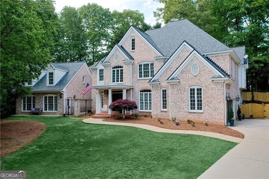 Tour this timeless three sided brick estate home complete with a beautifully appointed carriage house where refined craftsmanship meets everyday luxury. Step into the formal foyer and be greeted by a sophisticated dining room featuring elegant dental molding and wainscoting. Just off the foyer, a versatile home office space can easily serve as a formal living room to suit your needs. The heart of the home is the stunning family room with vaulted two story ceilings, a shiplap fireplace and seamless flow into the newly renovated kitchen.  Designed for both style and function, the kitchen boasts a large island, breakfast bar, stainless steel appliances with warming drawer, subway tile backsplash and a custom built surrounding refrigerator with abundant storage. An additional built-in sideboard with wine rack enhances the adjacent breakfast area. A butler's area or bar connects the kitchen to the main hallway, perfect for entertaining. The main floor also features a charming half bath with beadboard detailing, a full laundry room for added convenience and hardwoods throughout.  Upstairs, the oversized owner's suite offers a peaceful retreat with a tray ceiling, sitting area or second office space and a spa like bath complete with double vanities, a jetted bathtub, seamless glass shower with dual heads and a spacious walk-in closet with custom cabinetry.  A guest suite and two additional bedrooms connected by a jack and jill bath complete the second floor. The full unfinished basement offers second laundry hookups and endless potential whether you envision a home gym, theater or simply need ample storage. The Carriage House is such a bonus! This exceptional space includes a generous living /dining area combination, kitchenette with sink and fridge, a renovated full bath upstairs with a bedroom and an additional room perfect for an office or studio-ideal for guests, rental income or extended family.  2 car side entry garage; Nice walk out deck overlooks the landscaped and fenced backyard.