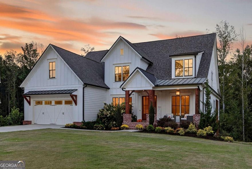 Crafted by esteemed builder Bercher Homes, this residence showcases the highly coveted Evans floor plan - one of West Cobb's most sought-after designs. Perfectly positioned at the end of a quiet cul-de-sac and framed by untouched natural landscape, the home offers rare privacy, timeless elegance, and an inviting sense of tranquility.    Upon entry, the grandeur of the two-story family room immediately captivates, where 20-foot ceilings rise above a dramatic two-story wood-burning fireplace. A Juliet balcony from the loft overlooks this magnificent space, while 10-foot ceilings on the main level and 9-foot ceilings upstairs enhance the sense of scale and light throughout. At the heart of the home, a chef's kitchen is equipped with a five-burner gas cooktop and an expansive 10-foot island that flows seamlessly into the family room. Walls of windows frame sweeping views of treetops and the surrounding natural landscape, creating a serene backdrop for everyday living and entertaining.    The main level is anchored by a refined owner's suite, complete with a custom boutique-style closet measuring 108 inches wide by nearly 18 feet deep - a retreat as functional as it is luxurious. From the suite, step out to a screened porch and oversized deck, where nature becomes a private extension of your living space. The breakfast area offers a daily connection to the outdoors, with views of lush greenery and the glimmer of the lake beyond.    Upstairs, three spacious bedrooms with en-suite access and generous walk-in closets are joined by a versatile loft space overlooking the family room. Below, a 2,500+ square foot unfinished basement presents a rare opportunity to create a bespoke retreat, whether envisioned as a wellness sanctuary, wine cellar, or home theater. Practical modernity is seamlessly woven in with an electric vehicle charging station already installed in the garage.    The lifestyle extends gracefully beyond the home itself. The community offers thoughtful amenities - including a pool, pickleball and tennis courts, clubhouse, and twin lakes for fishing and canoeing - all positioned nearby to preserve the home's privacy while enhancing an active and social way of life. Two private walking trails begin just beyond the property, connecting you effortlessly to nature.    Located in desirable West Cobb, this home is just seven minutes from vibrant Marietta Square, with its abundance of dining, boutiques, and community events. Historic Kennesaw Mountain offers trails steeped in history and natural beauty, while premier private schools - Mount Paran Christian (7 minutes), The Walker School (16 minutes), and North Cobb Christian (22 minutes) - are within easy reach. Kennestone Hospital is also minutes away, providing peace of mind.    This is more than a home; it is a statement of refined living - where architectural beauty, modern convenience, and natural tranquility converge in perfect balance.