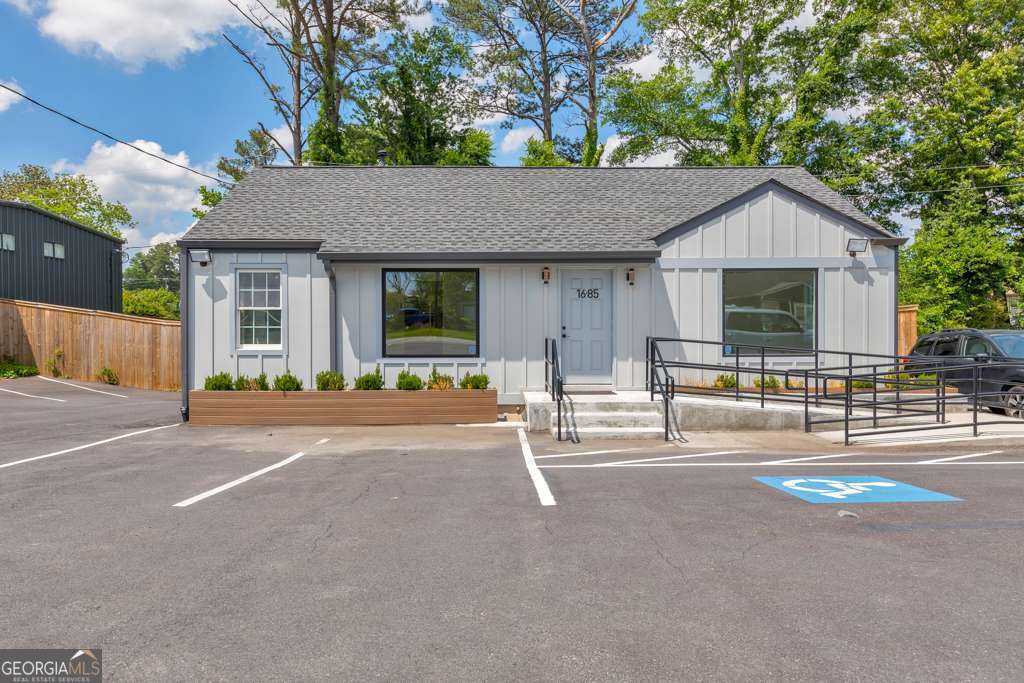 Unlock the potential of your business with this beautifully remodeled mixed-use space offering nearly 2,000 sq ft of functional and flexible layout. Situated on a high-visibility road, this property features excellent frontage and current parking for 6 vehiclesCowith plans underway to add 10 more spaces behind the building. Step inside to a spacious reception area that welcomes clients and guests, leading to four private offices on the main level. A shared kitchen with a sink, refrigerator, and microwave provides added convenience, along with one full bathroom and a half bath for staff and visitor use. Water access is available in every room, making this space ideal for a variety of business types. The lower level includes a large multi-purpose room perfect for a conference space, training area, or a fifth private office, along with an additional full bathroom. Two fenced areas behind the building offer added flexibility for storage, equipment, or secure outdoor use. This move-in ready space is ideal for professional offices, medical or wellness services, or creative studios. DonCOt miss this opportunity to elevate your business in a prime location!