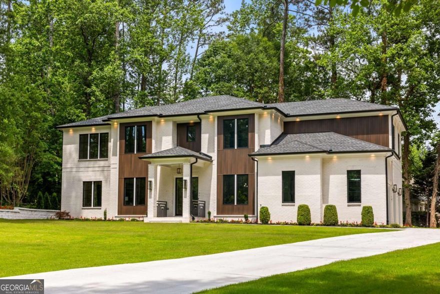 Listed under Appraisal Value!   Welcome to an architectural masterpiece nestled in the prestigious Indian Hills  community, where golf, swim, and tennis amenities complement this exquisitely  designed home. Upon arrival, custom exterior lighting sets a captivating tone,  warmly inviting you into a residence that blends modern elegance with thoughtful  functionality.  At the heart of the home, the gourmet chefCOs kitchen blends sleek modern  aesthetics with high-performance functionality. Custom flat-panel cabinetry pairs  elegantly with marble countertops, while the statement island stuns with a  waterfall edge, rich black and wood tones, geometric underlighting, and artisan  pendant fixtures. The kitchen is outfitted with professional-grade appliances,  including a luxury 60-inch refrigerator, a state-of-the-art 8-burner range with  integrated pot filler. Every culinary detail has been considered, from under-cabinet  LED lighting to soft-close features and illuminated interior shelving.  A seamless flow into the dining and living areas creates an entertainerCOs paradise,  further enhanced by a fully finished prep kitchenCoperfect for hosting while  keeping culinary artistry behind the scenes.  An elegant transition space between the kitchen and dining room is home to a  custom-built bar area, featuring illuminated cabinetry, under-cabinet wine glass  racks, bottle storage, and a built-in fridgeCoideal for sophisticated gatherings  Throughout the home, custom lighting installations elevate each space, including a  stunning chandelier in the grand foyer, sleek recessed lighting, and an illuminated  modern glass staircase that commands attention as a central design element. The  home also offers an elevator shaft, ready for future installation.  The primary suite is a serene retreat flooded with natural light, highlighted by  warm fire place, hardwood floors and a striking feature wall with vertical paneling.    The spa-like primary bathroom boasts floating dual vanities with vessel sinks, gold-  accented pendant lighting, a luxurious herringbone-pattern heated floor, and an    oversized glass walk-in shower clad in dramatic marble with multiple showerheads  for a truly indulgent experience.  Additional highlights include 6 spacious bedrooms, 6 luxurious bathrooms, a  versatile bonus room, and two distinct outdoor living areas Co one featuring a cozy  fireplace off the living room, and another perfectly suited for an outdoor kitchen  and grilling station.  Completing this remarkable home is an oversized 3-car garage, thoughtfully  designed with ample space for vehicles, storage, or a workshop. Equipped with a  220V electric vehicle charging outlet, this garage seamlessly blends functionality  with future-forward convenience for todayCOs modern lifestyle.  Every detail of this home has been meticulously curated to deliver an unparalleled  living experience thatCOs as stunning as it is functional.