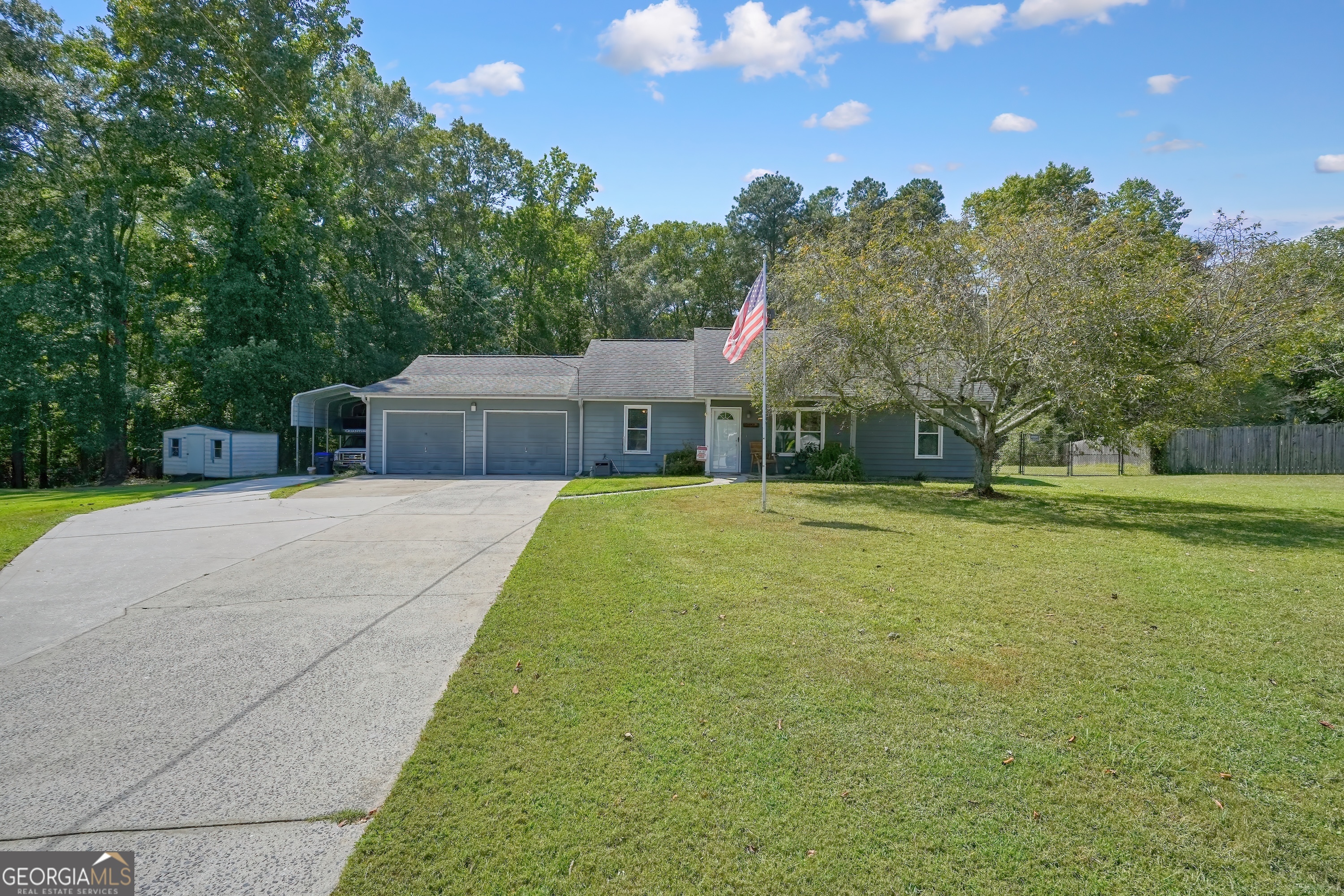 One story rancher perfectly situated on 3.1 private acres at the end of a quiet cul-de-sac. A classic rocking chair front porch sets the tone for relaxed country living, while key elements ensure comfort and convenience. Step inside to find hardwood laminate floors, vaulted ceilings in the open family room, and natural light from newer vinyl windows. The galley-style kitchen offers a functional layout, with all appliances included, making move-in seamless. The primary suite on main level provides a peaceful retreat with its ensuite bath and walk-in closet, while secondary bedrooms are comfortably sized for family or guests. A fenced backyard offers endless space for play, pets, or future expansion. Car enthusiasts and hobbyists will appreciate the oversized two-car attached garage, a 36-foot RV/5th wheel carport, and a 2nd driveway providing easy access. With a durable 30-year architectural shingle roof and hardy plank siding, this home is built to last. Ideally located, you'll enjoy the quiet of country living with quick access to shopping, dining, and scenic outdoor trails just minutes away. This property is the perfect blend of farmhouse charm, practical features, and acreage privacy-ready to welcome its next owner.