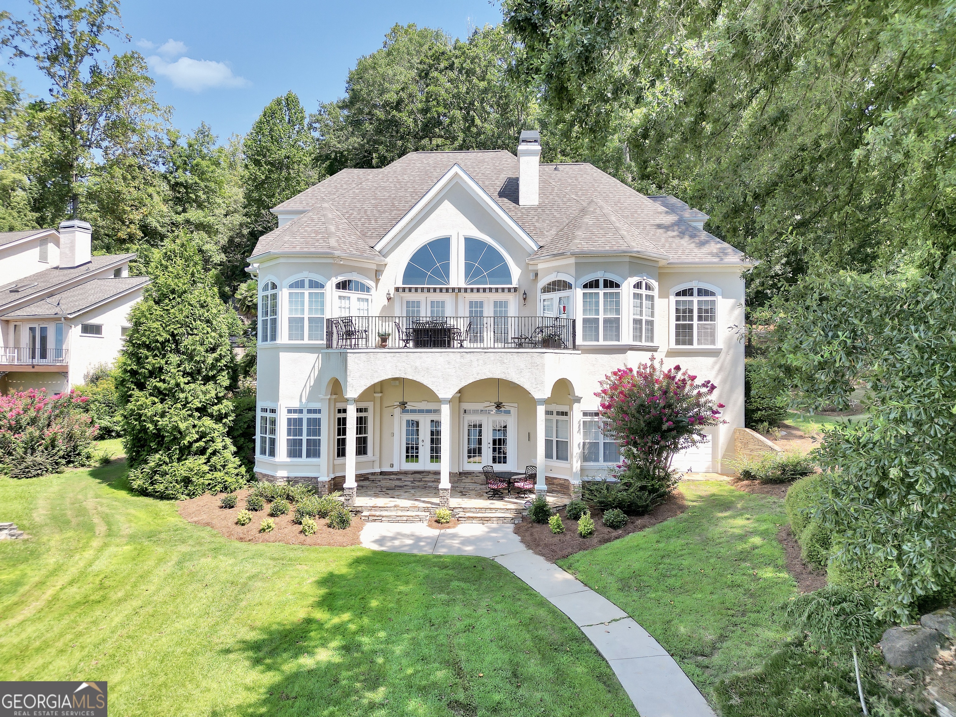 Deeded Waterfront Living on Jackson Lake - A True Masterpiece Experience lakefront living at its finest in this stunning luxury home nestled on the shores of Jackson Lake. Boasting 5 spacious bedrooms and high-end finishes throughout, this exceptional property is designed for comfort, style, and effortless entertaining. Step into the bright and airy living room, where natural light pours in through expansive windows framing breathtaking big water views. The heart of the home is the chef's gourmet kitchen, featuring sleek quartz and granite countertops, custom cabinetry, and top-of-the-line appliances-perfect for hosting or crafting gourmet meals. The main-level master suite offers a peaceful retreat with lake views, a spa-inspired bathroom, and an oversized walk-in closet. Downstairs, the fully finished basement is an entertainer's dream-complete with a theater room, a huge wet bar with a full-size refrigerator, and multiple areas for gathering and relaxing. Enjoy lake life year-round with your covered two slip Trex dock with two lifts, ideal for boating, fishing, or simply soaking in the serene surroundings. Additional highlights include: * Lavish master bath with separate jacuzzi style tub, his and her and double vanities * Elegant high ceilings and premium finishes throughout * Ample storage and thoughtful layout for full-time living or vacation getaways * deep water for swimming at the dock. * inground sprinkler system Whether you're entertaining a crowd or enjoying quiet lakefront sunsets, this one-of-a-kind Jackson Lake estate offers luxury, comfort, and unforgettable views.