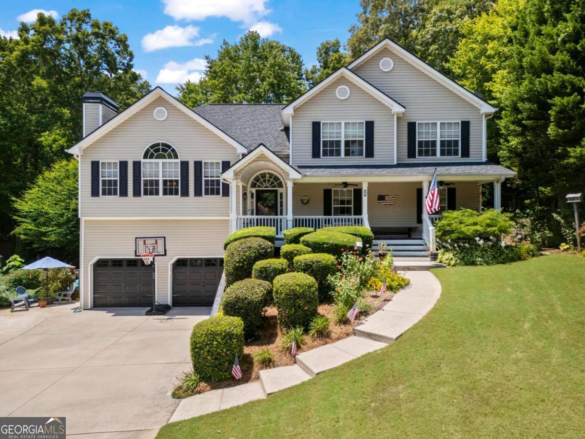 This beautifully maintained split-level home in the sought-after Etowah School District offers a versatile floor plan, modern updates, and plenty of space for everyone. The main level features a spacious primary suite with a sitting area, large secondary bedrooms, and updated light fixtures throughout. The bright and inviting living area boasts vaulted ceilings, a cozy fireplace, and built-ins that add both charm and functionality. The kitchen includes a subway tile backsplash, newer appliances, and two new storm doors. The fully finished basement, completed in 2020, offers a gym, full bath, bedroom, and living area with kitchenette-making it ideal for an in-law or teen suite. Major updates include a new roof (2018), new garage doors with openers (2019), new water heater (2021), new garbage disposal, and an insulated and sealed attic with a tent cover for improved energy efficiency. The garage walls and floor have been freshly painted, and an additional parking pad has been added for convenience. Outdoor living is a true highlight with a private above ground pool, a rocking chair front porch that spans the length of the home, a fantastic yard perfect for entertaining, and space to enjoy all four Georgia seasons. The property also includes a replaced and painted deck, backyard shed, and the added bonus of NO HOA. Built-ins in the laundry room and thoughtful updates throughout make this home completely move-in ready. Conveniently located near shopping, dining, and top-rated schools, this home truly has it all!