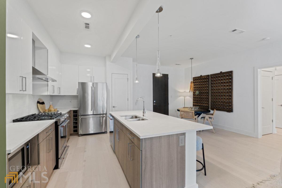 Brand new luxury condominiums in the heart of Midtown! Ready for immediate closings. J5 offers the ultimate in Intown living: quality construction, convenient location, unmatched service and amenities. This 5th floor residence is a mid-town oasis in the heart mid-town. This 2-bedroom 2 bath home features a split floorplan, floor to ceiling windows and an oversized balcony. All homes feature bright, open entertaining areas, wide plank hardwood flooring, stainless steel KitchenAid appliance packages with gas cooking, and quartz countertops and islands. Unwind on your private balcony or soak up the sun next to the saltwater pool. Garden Courtyard amenity offers fresh herbs for your chef-inspired dinner! 24-hour concierge, state-of-the-art fitness center, pet spa, and a roof terrace open-air lounge.