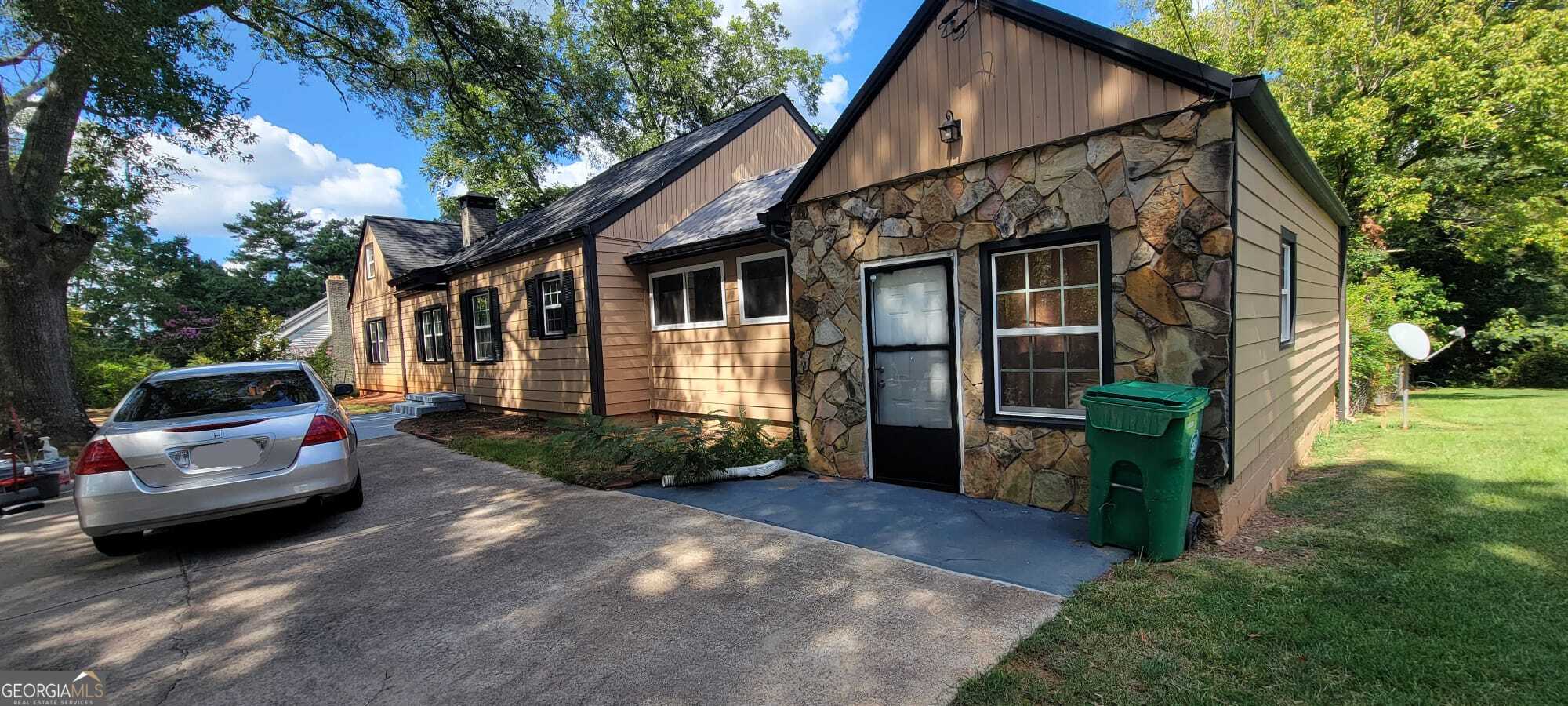 Welcome to your new home in the heart of Stone Mountain! Sitting on almost an entire acre lot, this spacious 4-bedroom, 3-bath residence blends comfort and convenience with easy access to schools, parks, shopping, and major highways. Inside, you'll find an open living area filled with natural light, a modern kitchen with ample cabinetry and counter space, and a versatile floor plan perfect for both everyday living and entertaining. The generously sized bedrooms include a private primary suite with its own bath, while the additional baths offer updated fixtures and plenty of storage. Outside, enjoy a level backyard ideal for gatherings, gardening, or play. Just minutes from Stone Mountain Park, this home offers the perfect combination of suburban tranquility and city convenience.