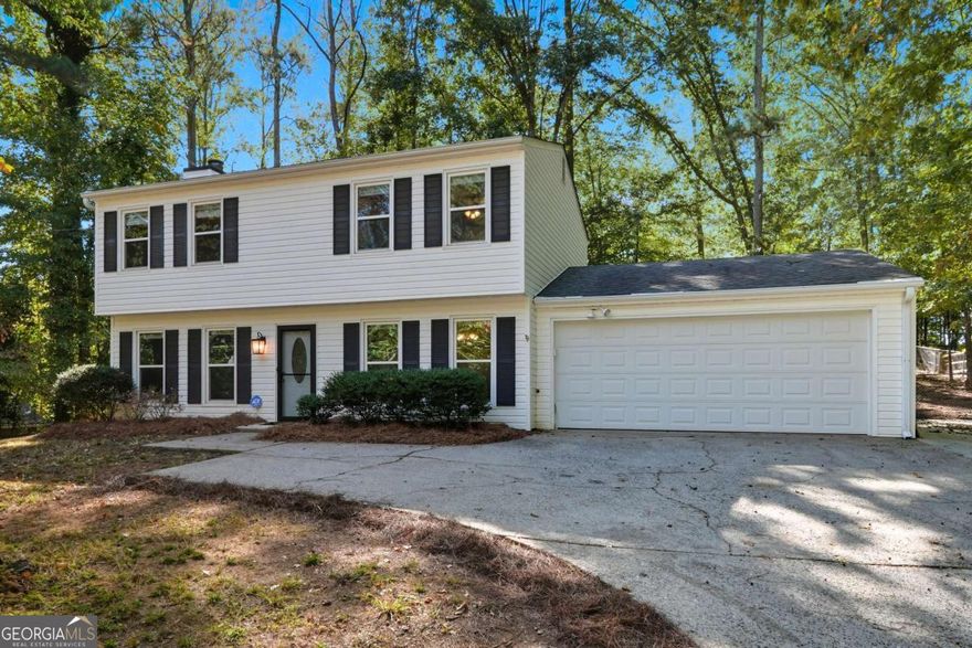 Welcome to this beautifully renovated 3-bedroom, 2.5-bath home, ideally situated on a private cul-de-sac lot in the tranquil Rock Mill neighborhood. This home offers a perfect blend of timeless character and modern comforts.    Step into the main level featuring engineered wood flooring flowing through the formal dining room and family room which is anchored by a brick fireplace. The spacious sunroom offers incredible versatility-perfect as a second den, playroom, home office, or anything else your heart desires. Upstairs, the generous primary suite includes an updated bath with modern finishes, while the secondary bedrooms are roomy and inviting. The updated kitchen features granite countertops, stainless steel appliances, and plenty of storage-ready for your favorite meals and gatherings.    Outside, enjoy private surroundings and a quiet lot in a top-rated Cobb County school district. This home is truly move-in ready and offers the perfect mix of style, comfort, and location.
