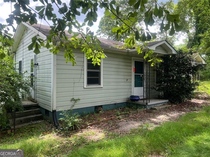 Investor's Dream - Huge Potential! 2 Bed, 1 Bath home on nearly one acre of land! Renovate the existing structure or build your custom project. Zoning possibilities and lot size offer endless development opportunities. Don't miss this rare find!